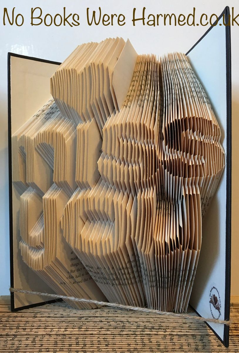 A unique hand-folded book art piece titled 'Miss You', crafted from vintage books, showcasing intricate designs and textures.