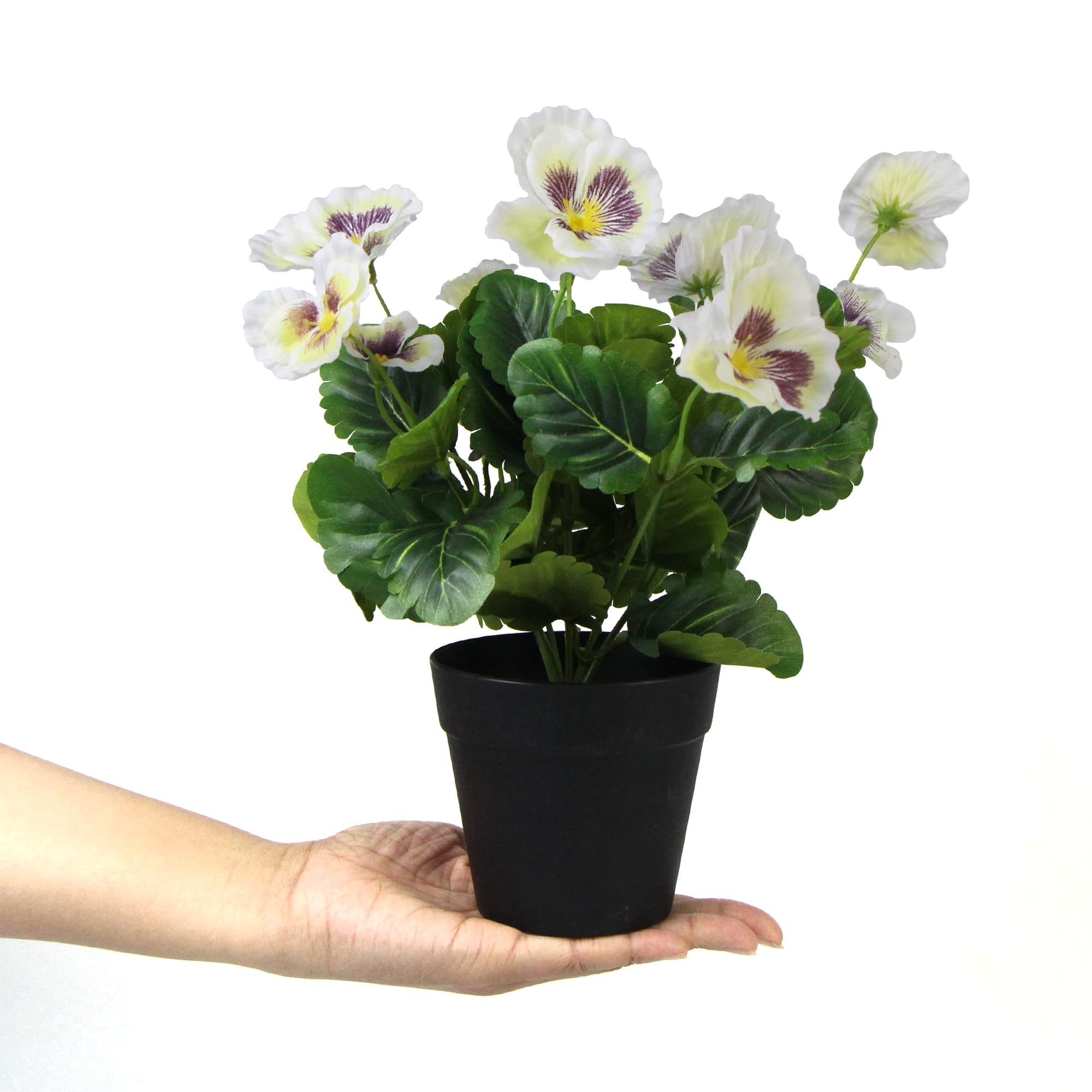 A beautiful arrangement of mixed white flowering artificial pansy plants in a decorative pot, showcasing realistic blooms and lush green leaves.