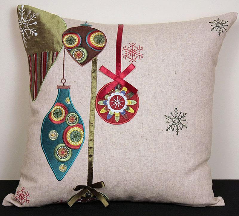 ML12001 Noel Ornaments Holiday Pillow featuring colorful embroidered Christmas ornaments, ribbons, and jingle bells on a natural muslin background.