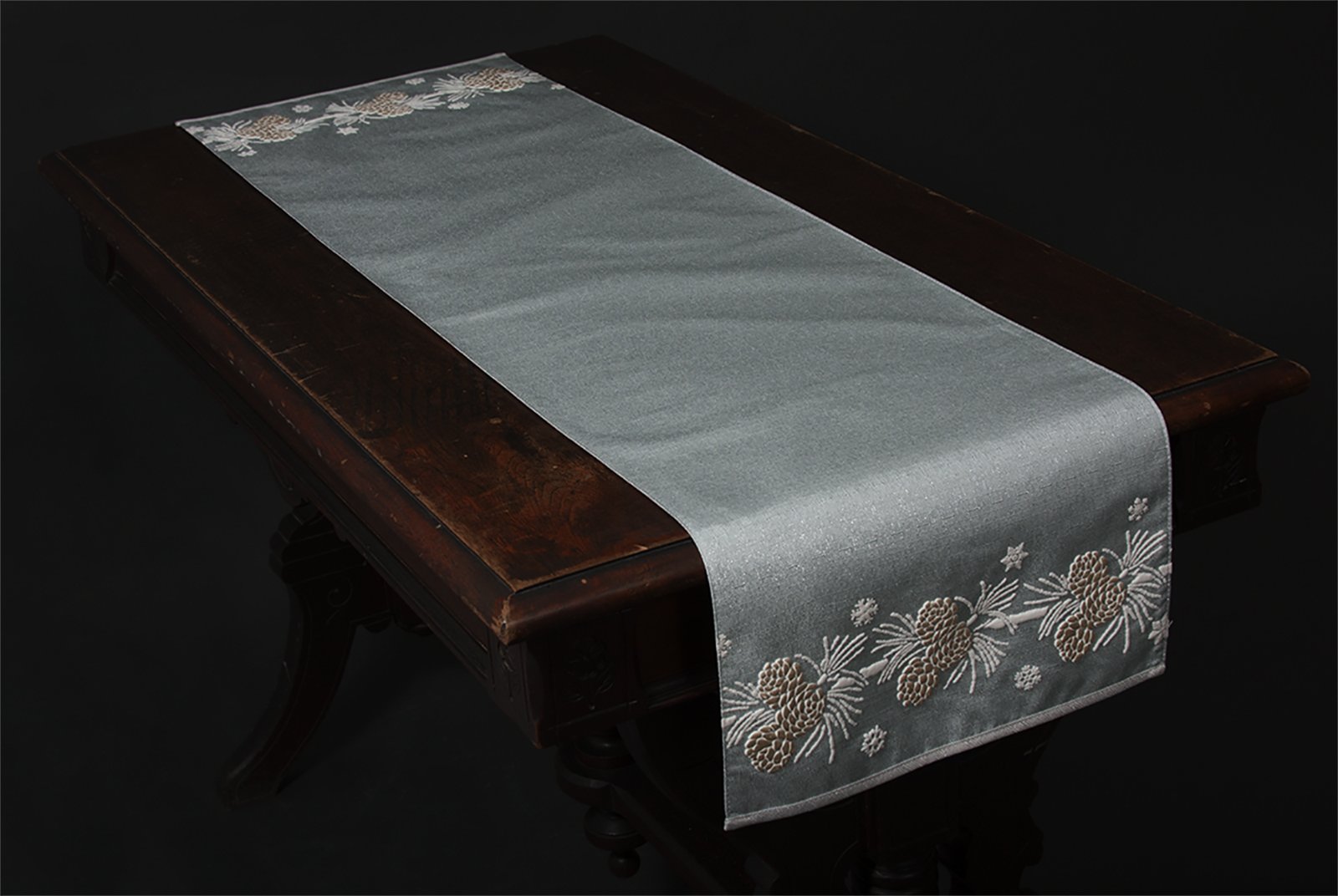 ML17117 Winter Pine Cone Table Runner featuring frosted pine cones on a shimmering winter blue background, perfect for holiday decor.