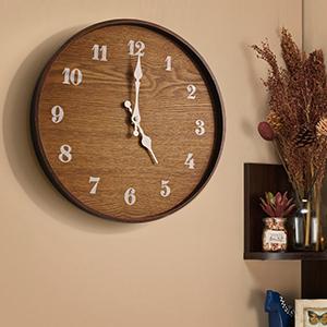 A stylish 13-inch modern wall clock made of real wood with hand-painted numbers and cast iron hands, perfect for home decor.