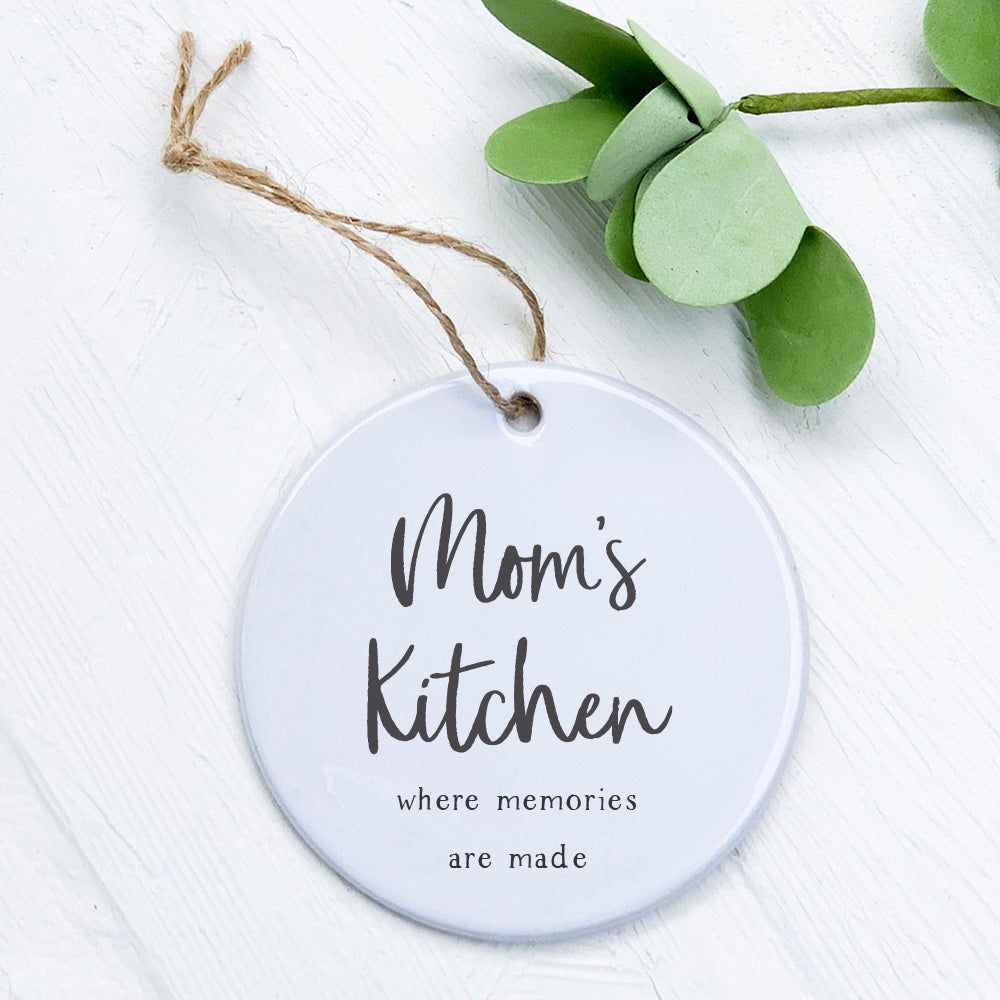 Mom's Kitchen Ornament made of high-quality porcelain with original designs, featuring a smooth gloss finish and measuring 2.75 inches in diameter.