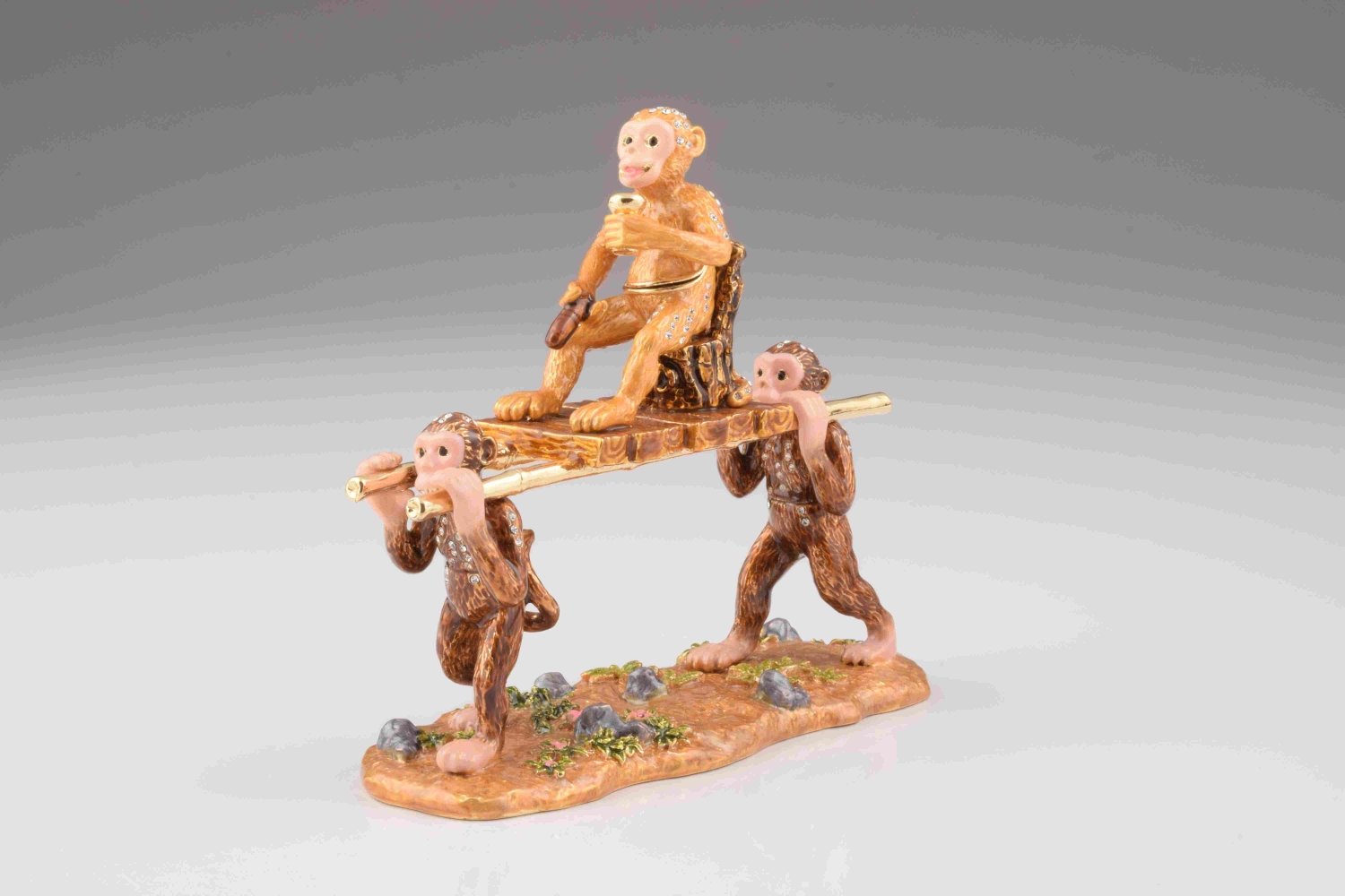 A beautifully crafted trinket box featuring monkeys carrying the Monkey King, adorned with Austrian crystals and plated in 24K gold.