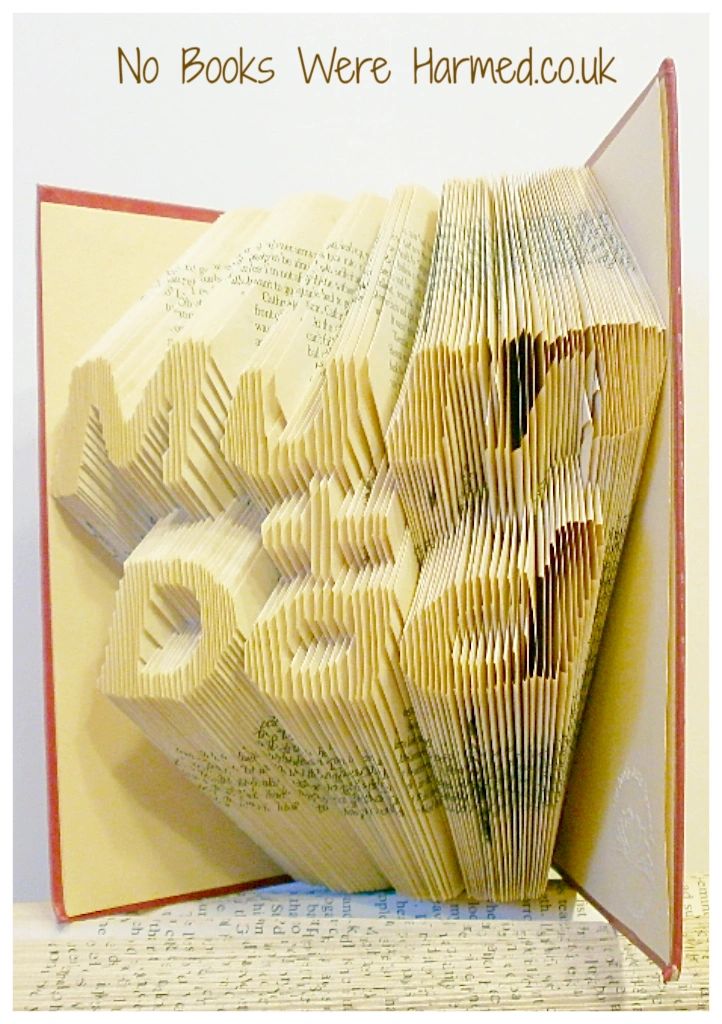 Handcrafted 'Mum + Dad' book art made from vintage books, showcasing unique hand-folded pages in a beautiful design.