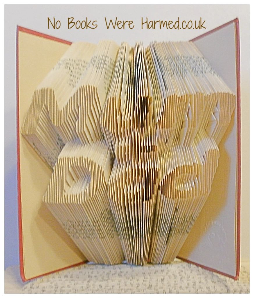 Handcrafted 'Mum + Dad' book art made from vintage books, showcasing unique hand-folded pages in a beautiful design.