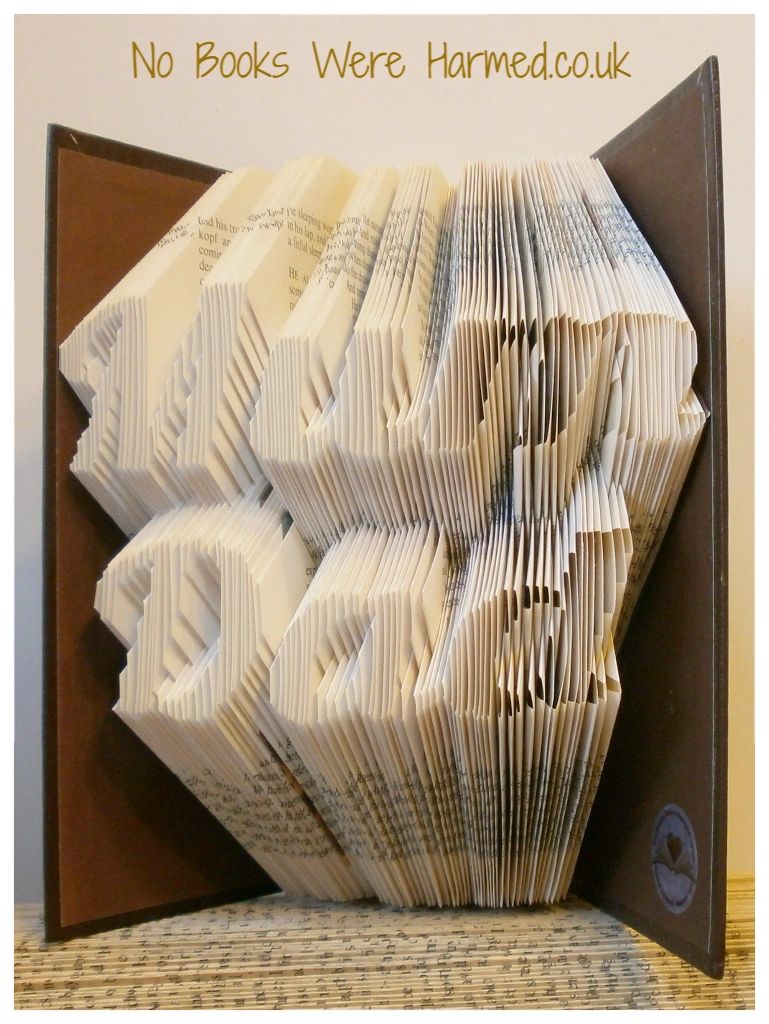 Handcrafted 'Mum Dad' book art made from vintage books, showcasing intricate page folds and unique design.