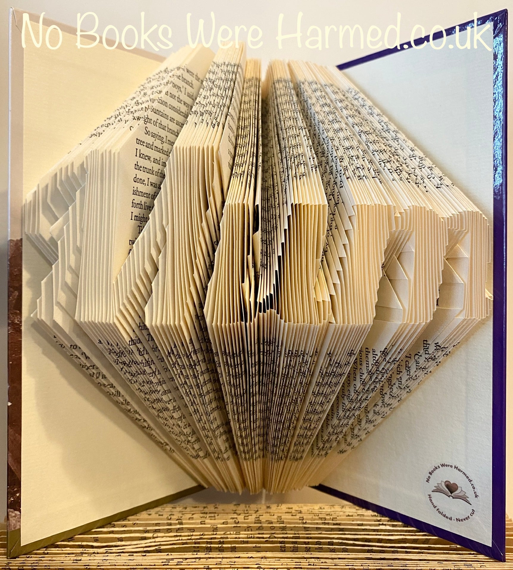 Hand-folded book art piece titled 'Mum', showcasing intricate designs made from vintage book pages.