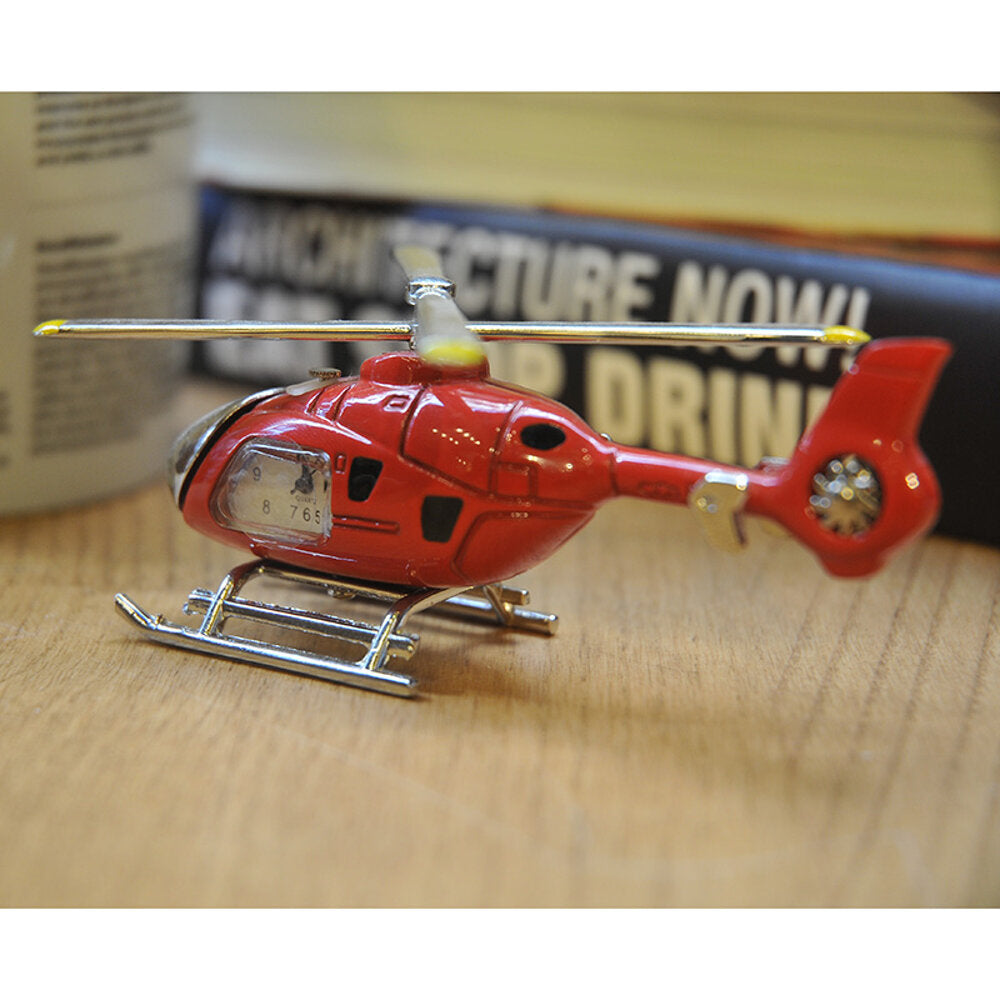 Nektar Tischuhr in Hubschrauberform, rote Farbe mit weißem Zifferblatt, dekorativ und funktional.