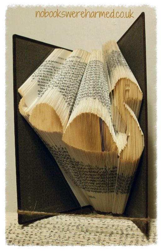 Hand-folded art piece of the Loch Ness Monster made from vintage book pages, showcasing intricate craftsmanship and unique design.