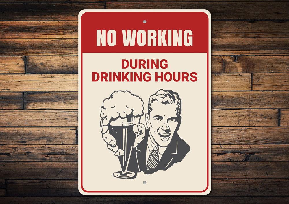 No Working During Drinking Hours Sign made of high-quality aluminum, featuring humorous text, ideal for home bars and man caves.