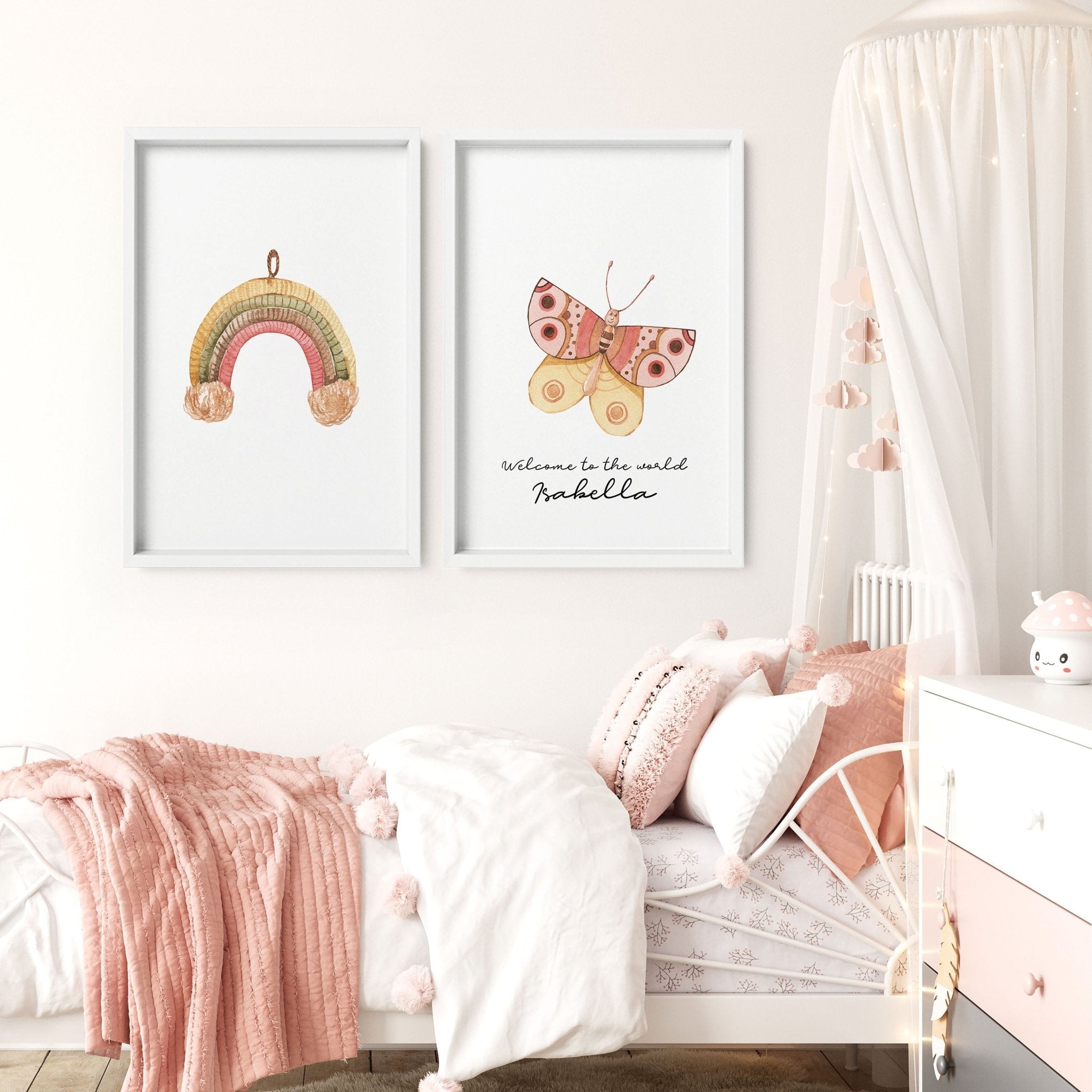 Set of 2 framed nursery wall art prints featuring a bohemian rainbow and butterfly design in soft blush colors.