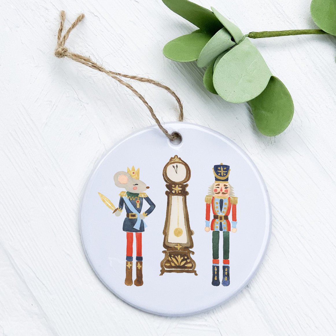 A beautifully crafted porcelain ornament featuring a Nutcracker, Mouse King, and Clock design, showcasing vibrant colors and intricate details.