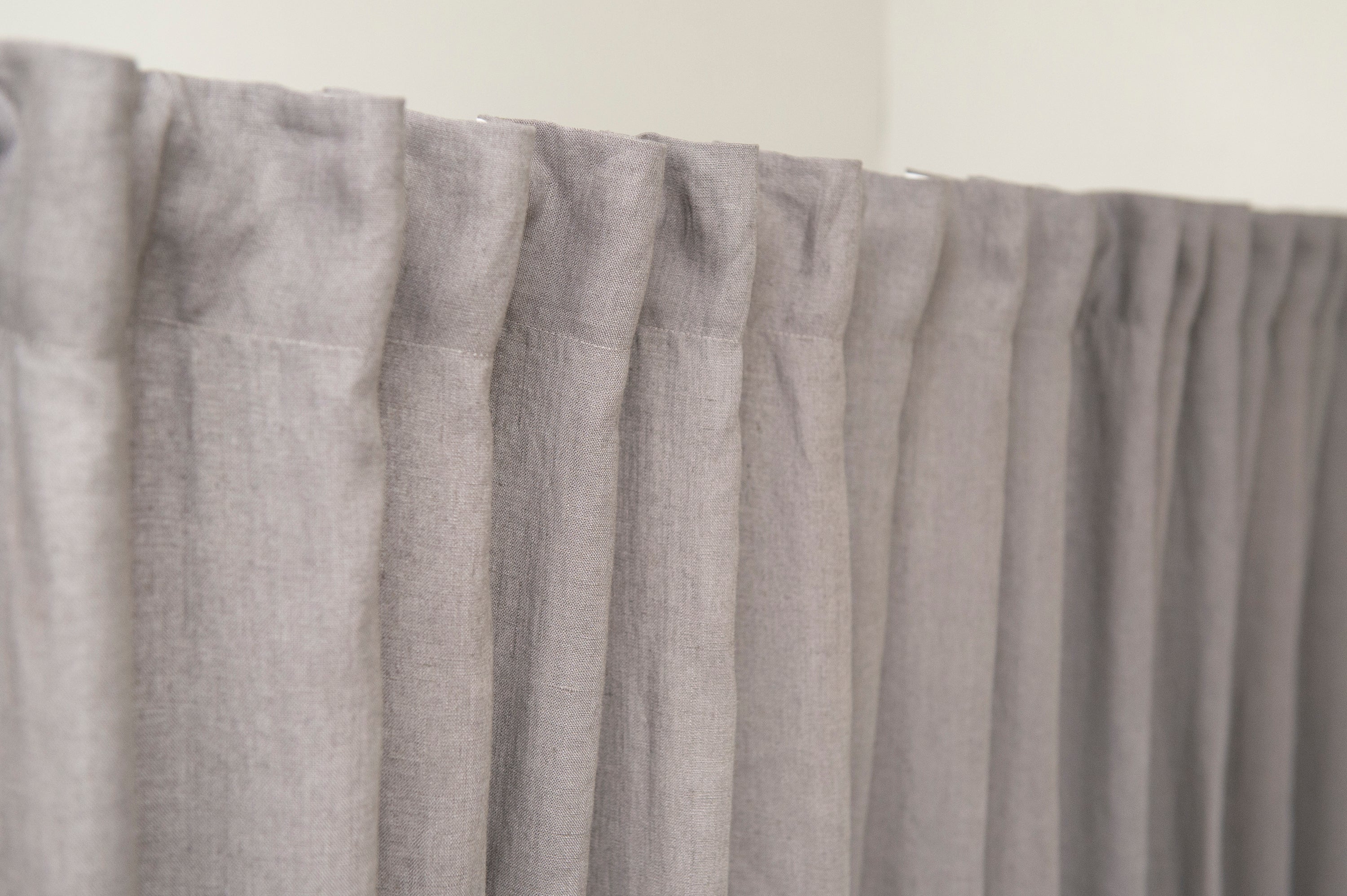 Pastel Plum linen curtain with multifunctional heading tape, elegantly draped to showcase its soft texture and color.
