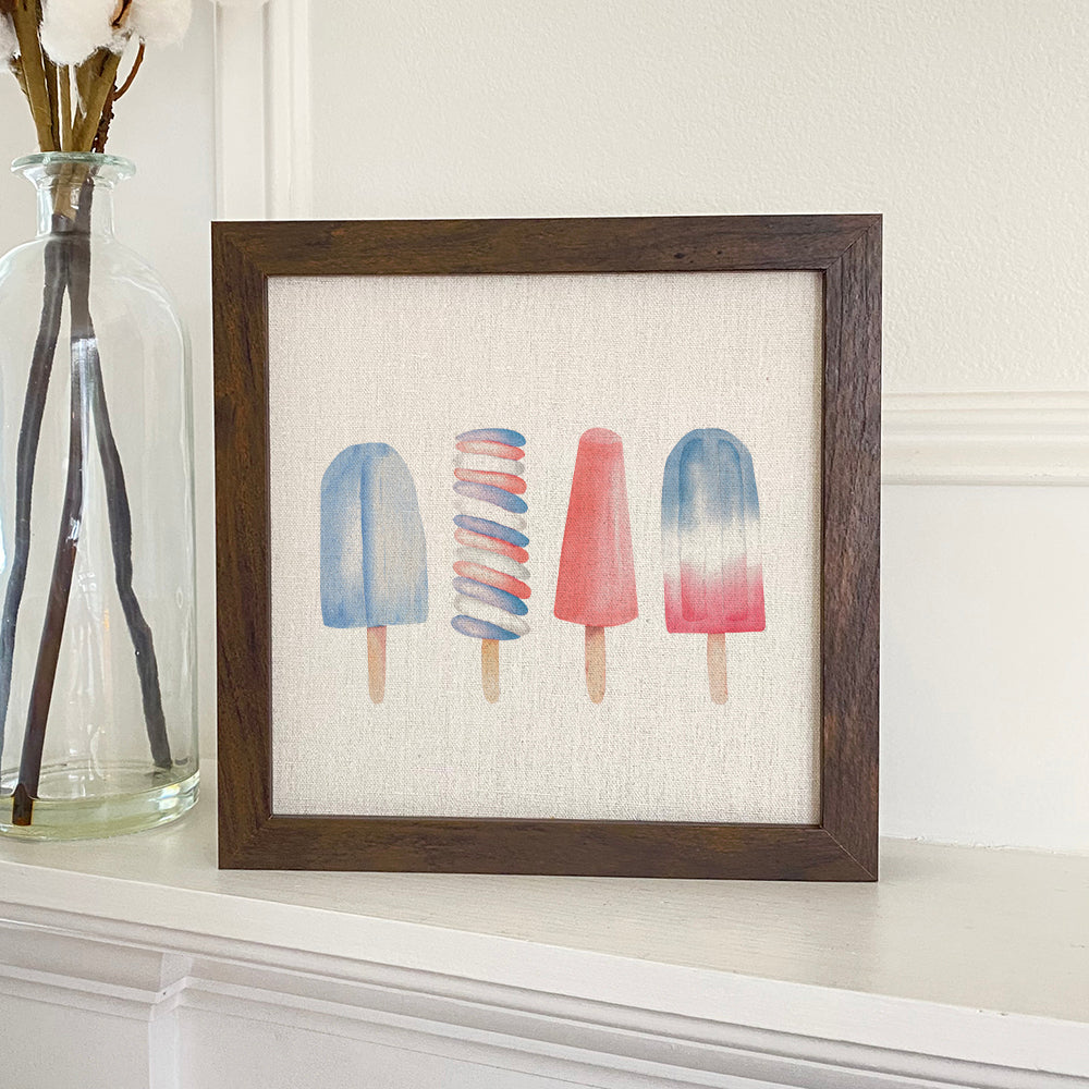 Patriotic Popsicle framed sign with a linen-look background and wooden frame options in walnut and white-washed finishes.