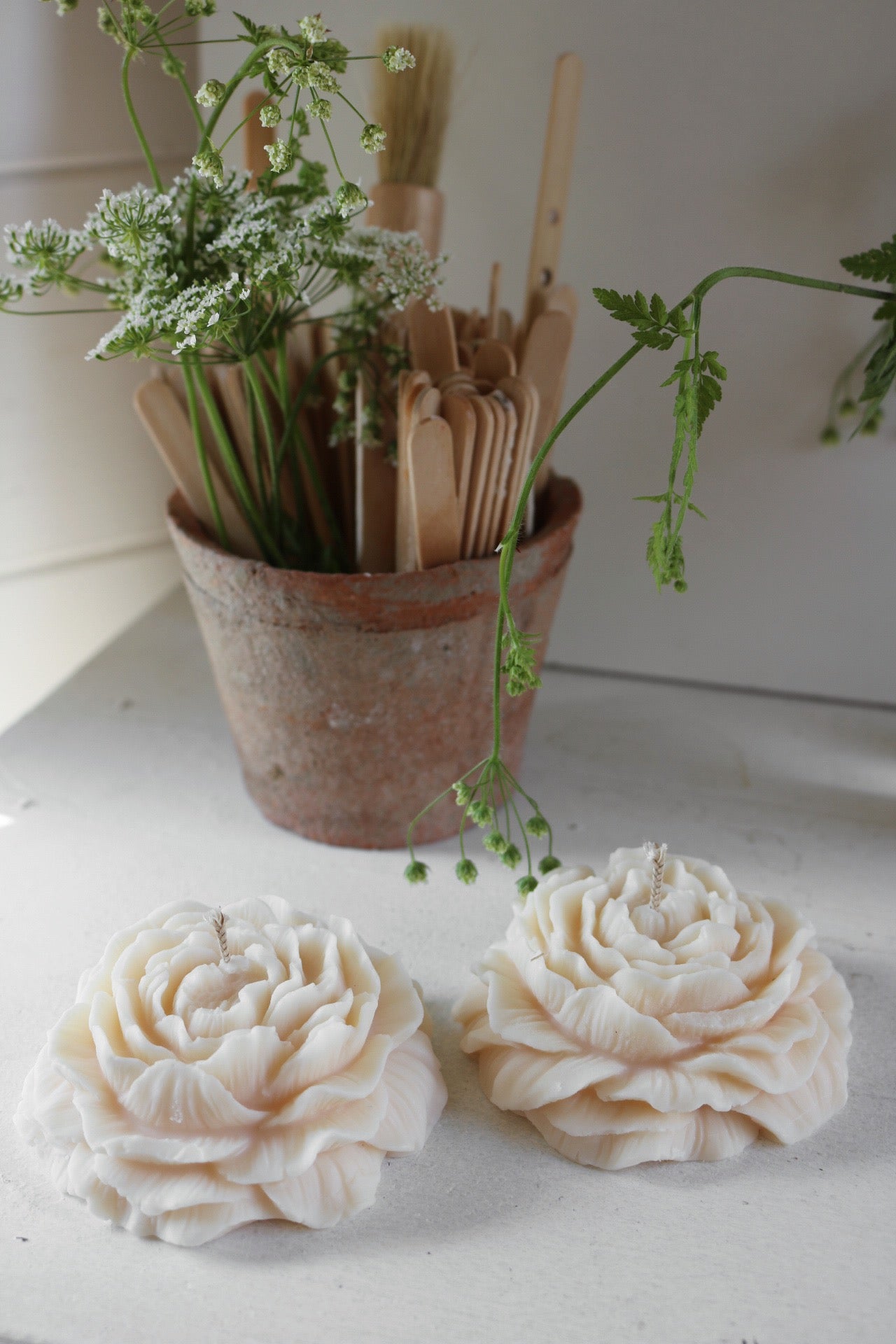 A beautifully sculpted Peony candle made from a soy wax blend, showcasing its elegant design and soft color, perfect for home decor.