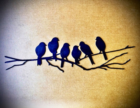 Metal wall art featuring six love birds perched on a branch, crafted from polished steel with a dark gray patina.
