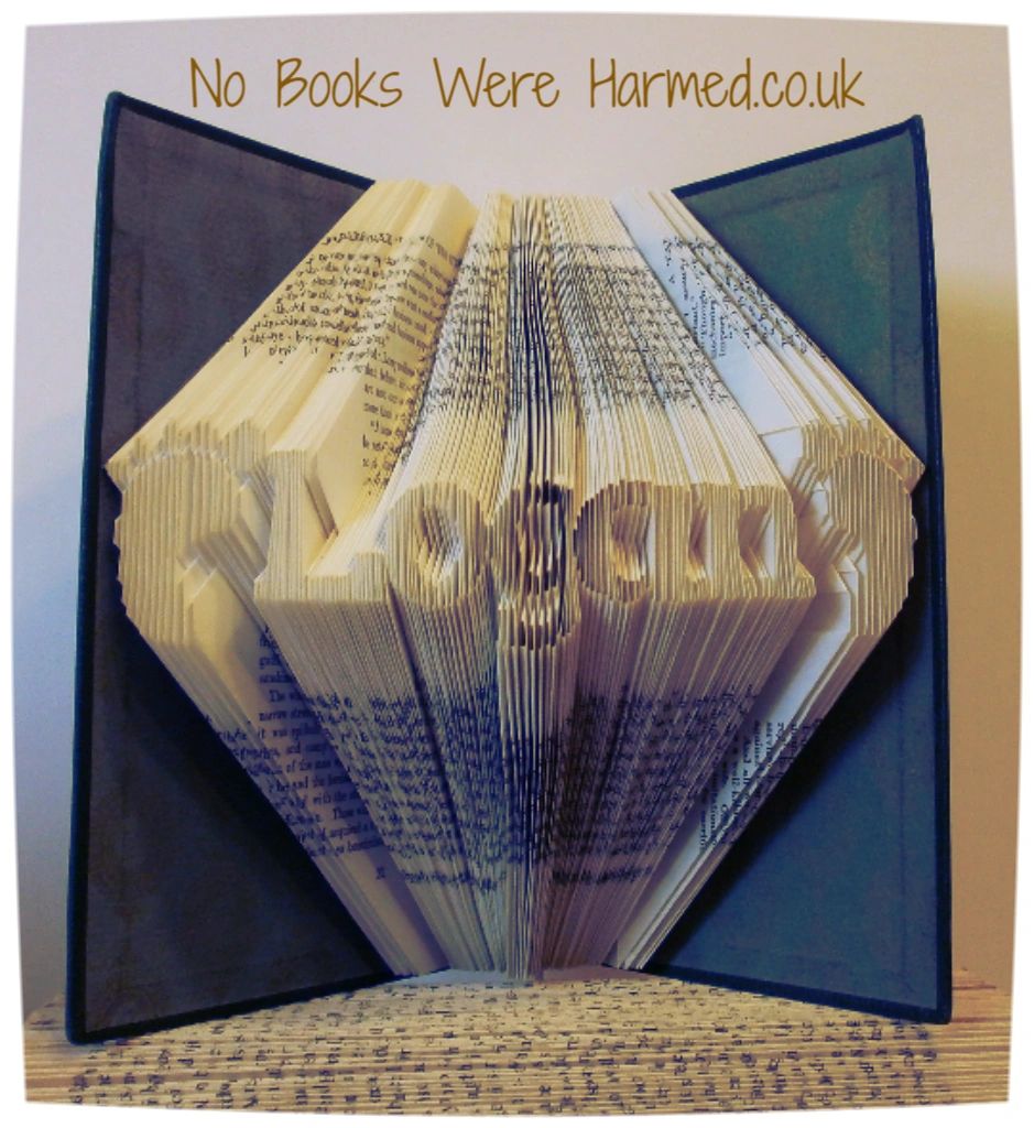 A beautifully crafted personalised baby feet keepsake book made from vintage materials, showcasing unique hand-folded pages.