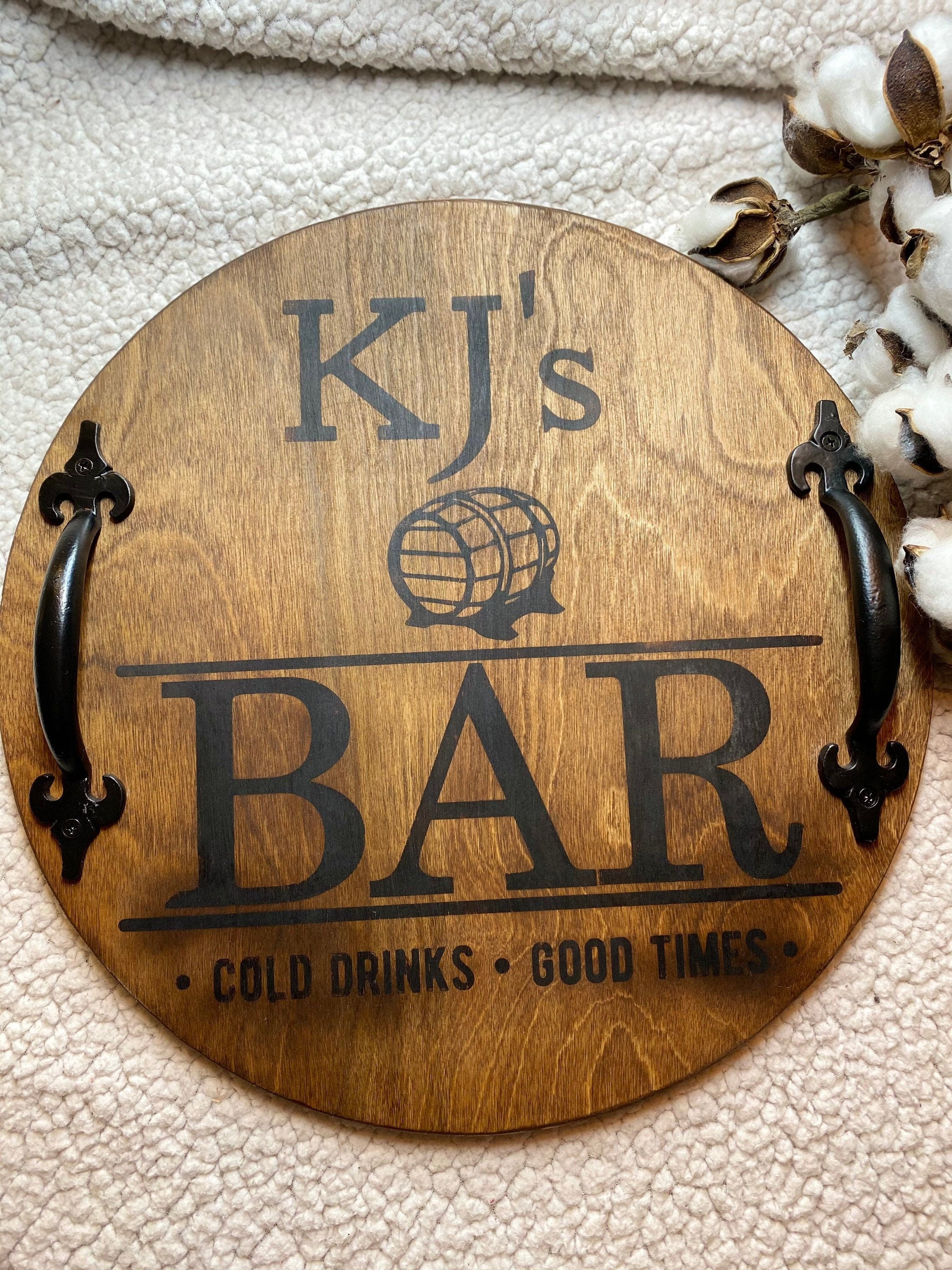 Personalized bar wood serving tray made of birch plywood, stained in Chestnut, featuring black metal handles and custom name engraving.