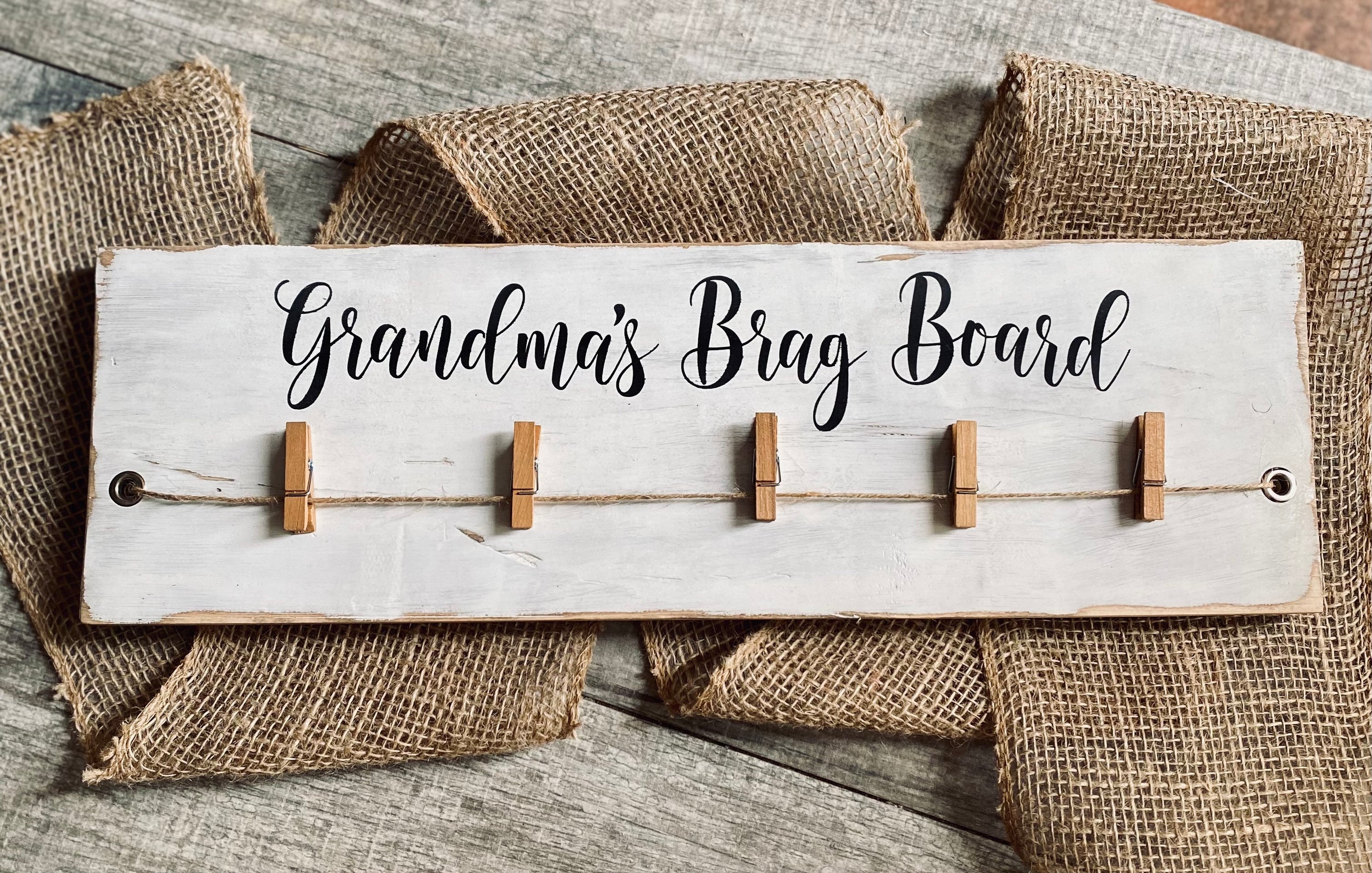 Personalized Brag Board Photo Display showcasing photos and artwork with customizable name options.