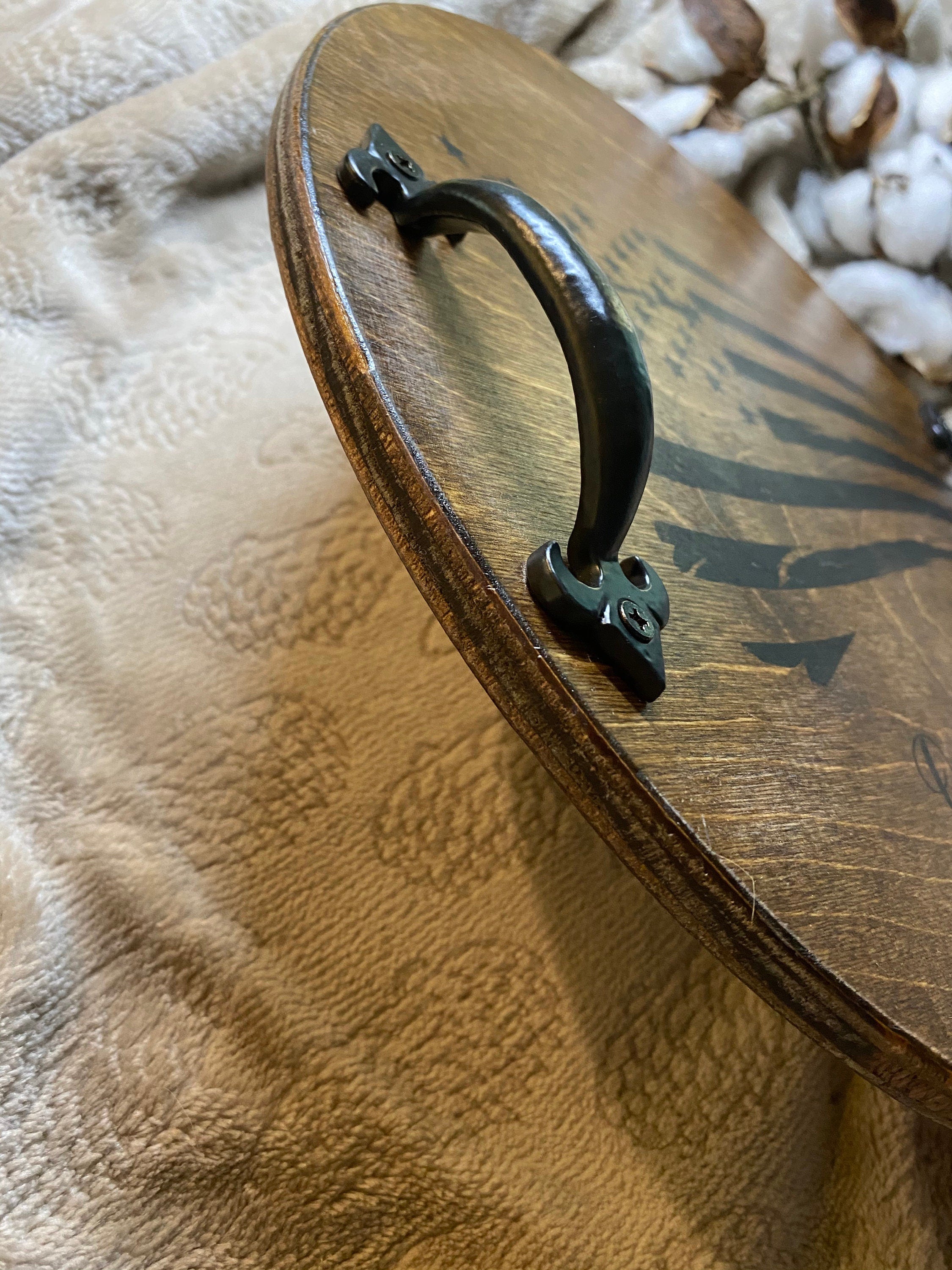 Handmade personalized serving tray for mom, featuring names burned into rich dark chestnut stained birch plywood with black metal handles.