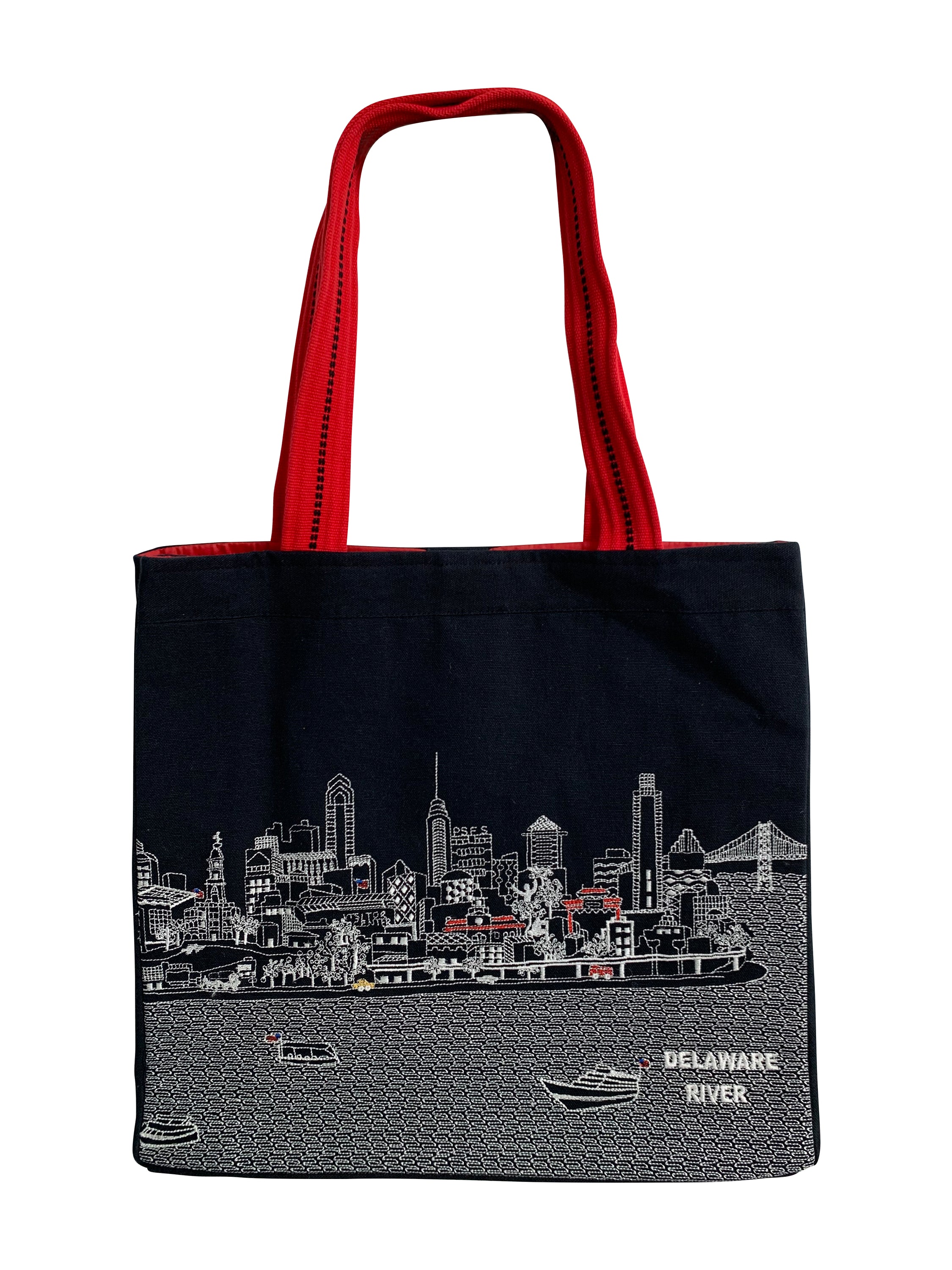 Stylish Philadelphia Tote Bag with embroidered skyline design in cream and black colors, featuring red waterproof lining and ribbed straps.