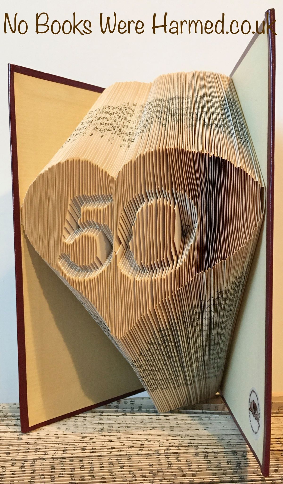 Handcrafted love heart art made from vintage book pages, featuring customizable numbers.