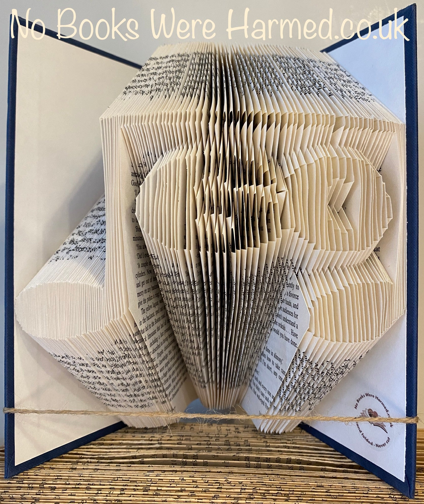 Handcrafted music note art made from vintage book pages, featuring unique hand-folded designs and personalized number options.