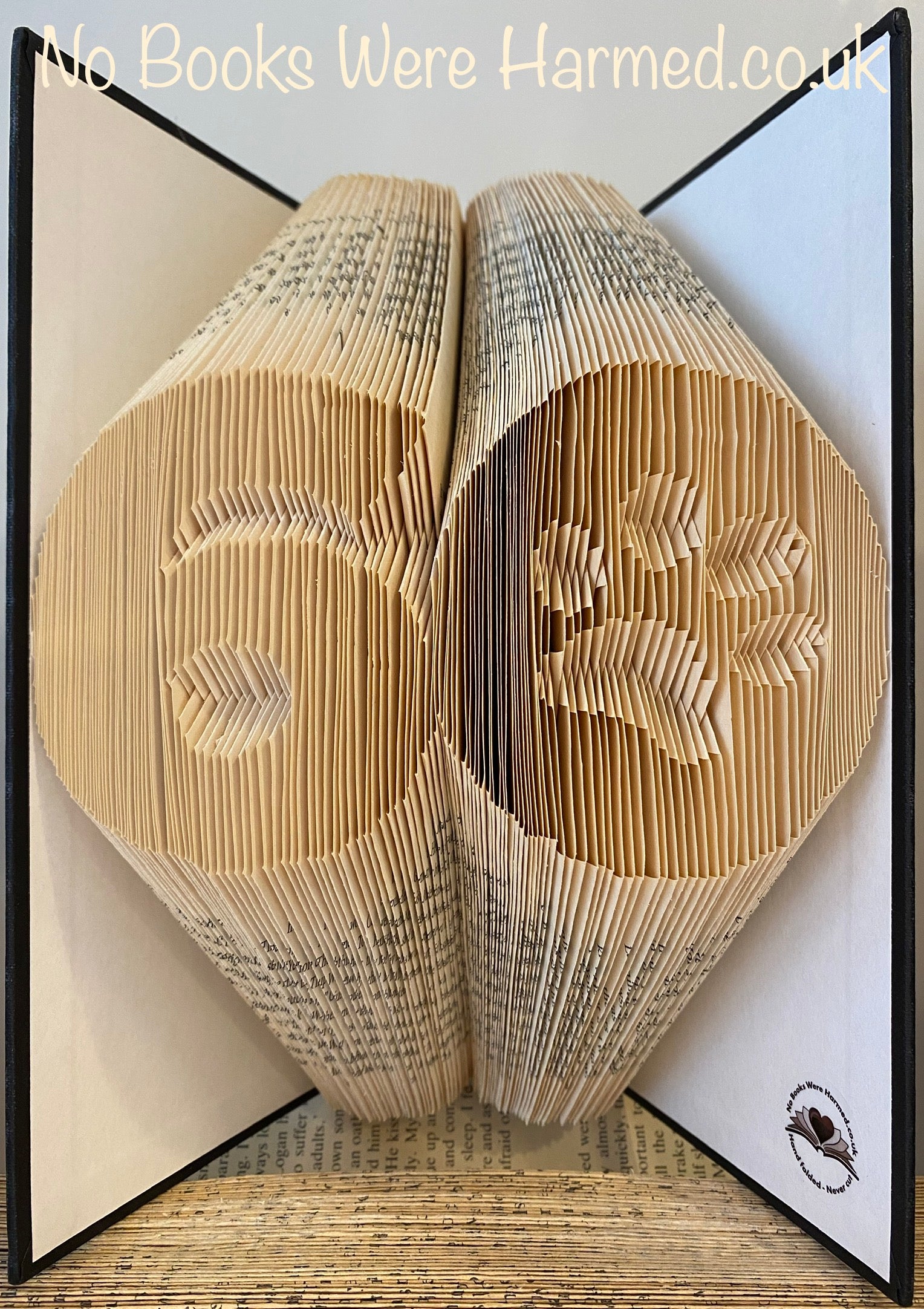 Custom big birthday numbers with a paw print in the 0, handcrafted from vintage book pages, showcasing unique colors and textures.