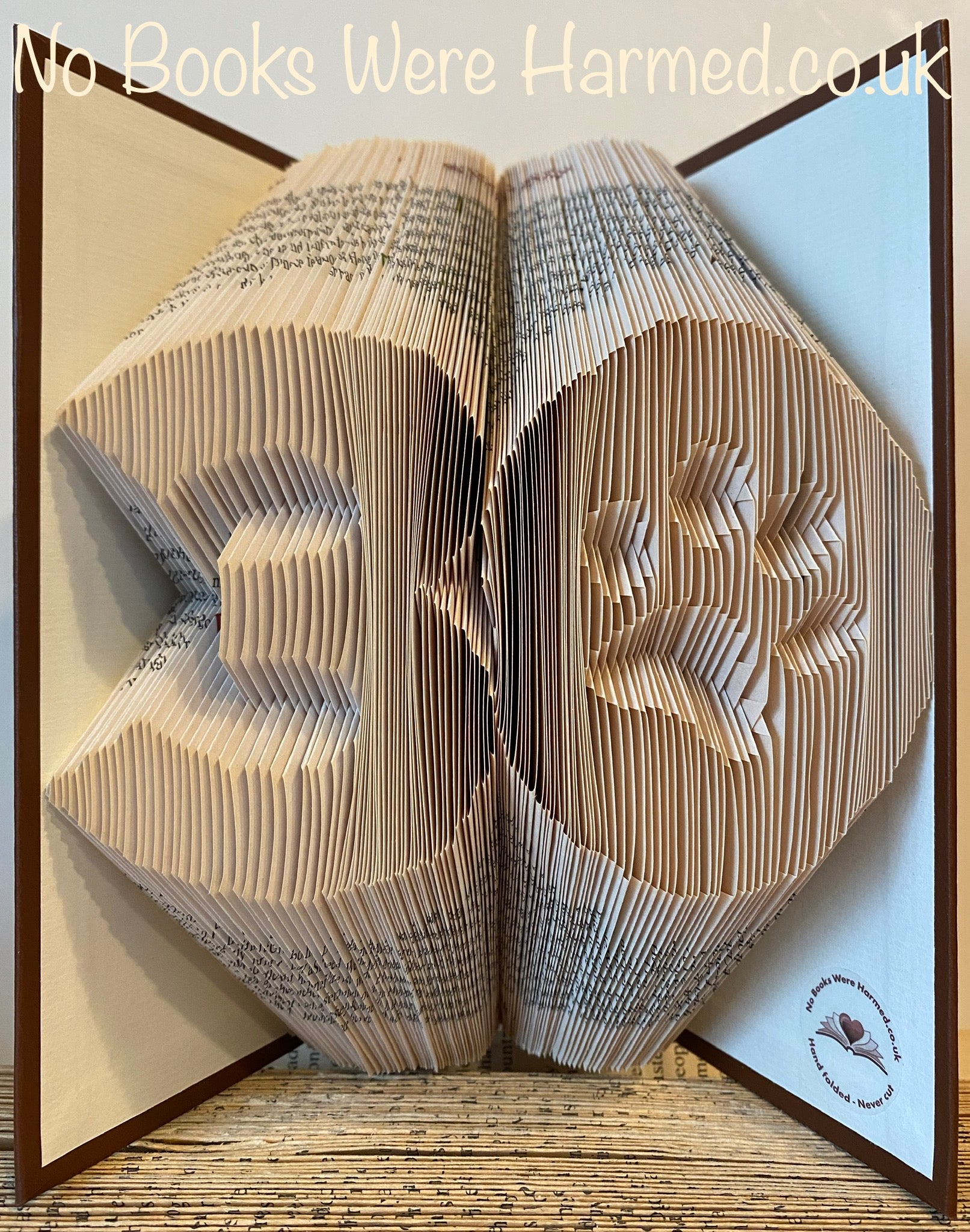 Custom big birthday numbers with a paw print in the 0, handcrafted from vintage book pages, showcasing unique colors and textures.