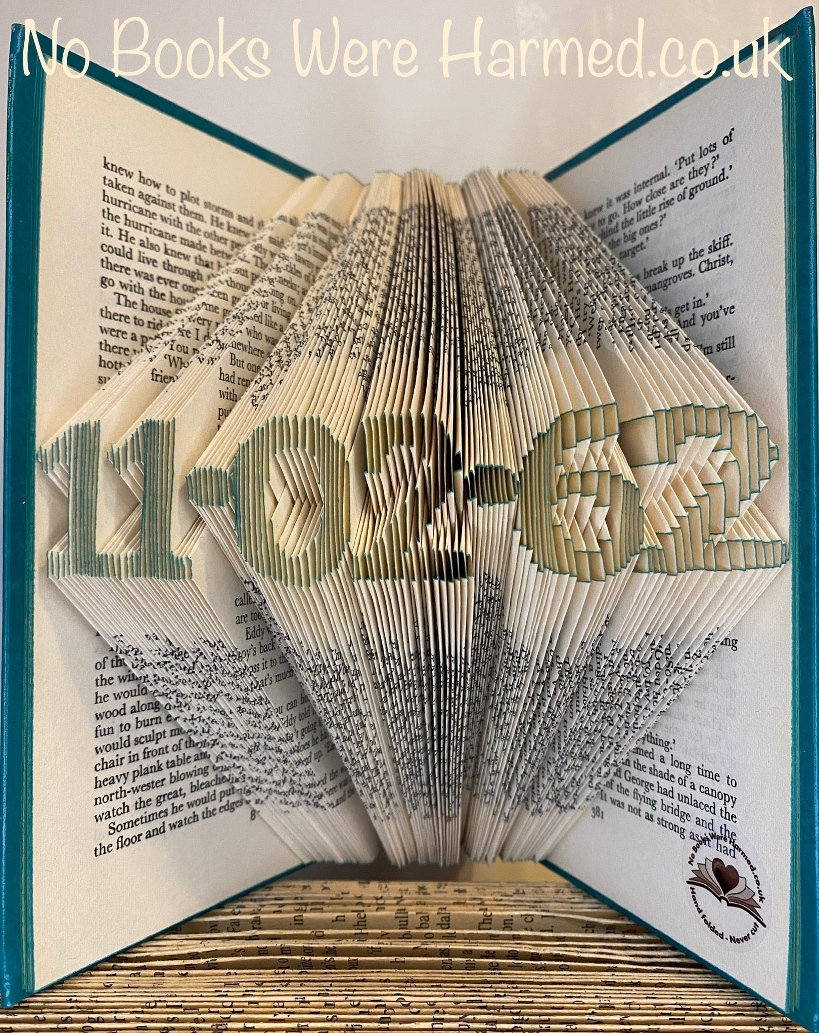 A beautifully crafted mini personalised keepsake date made from vintage book pages, showcasing intricate hand-folded designs.