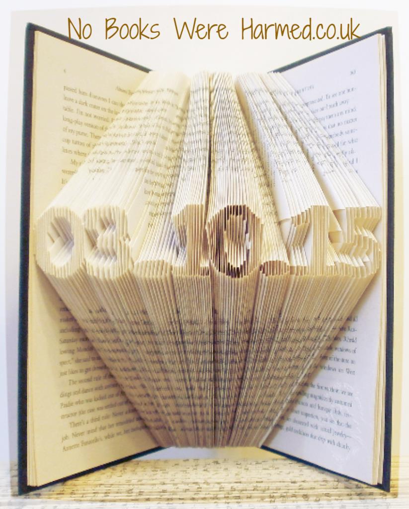 A beautifully crafted mini personalised keepsake date made from vintage book pages, showcasing intricate hand-folded designs.