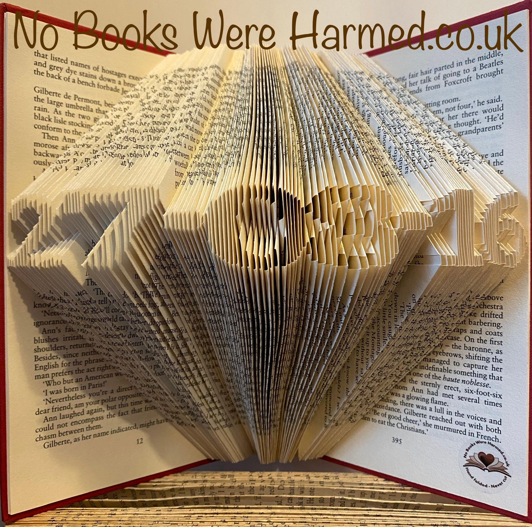 A beautifully crafted mini personalised keepsake date made from vintage book pages, showcasing intricate hand-folded designs.