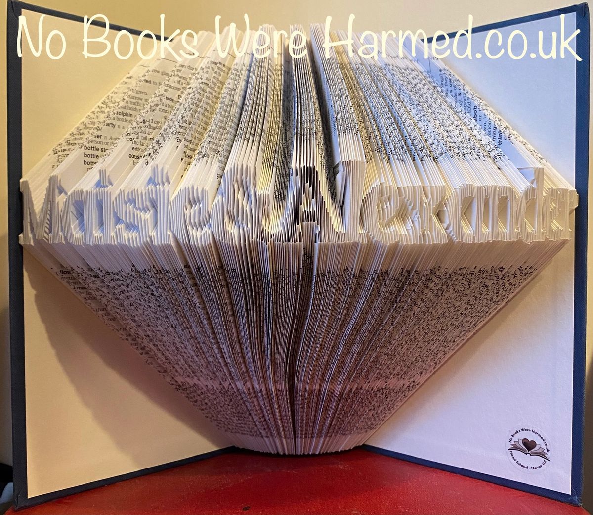 Hand-folded book art displaying a custom word, showcasing unique vintage pages and intricate lettering.