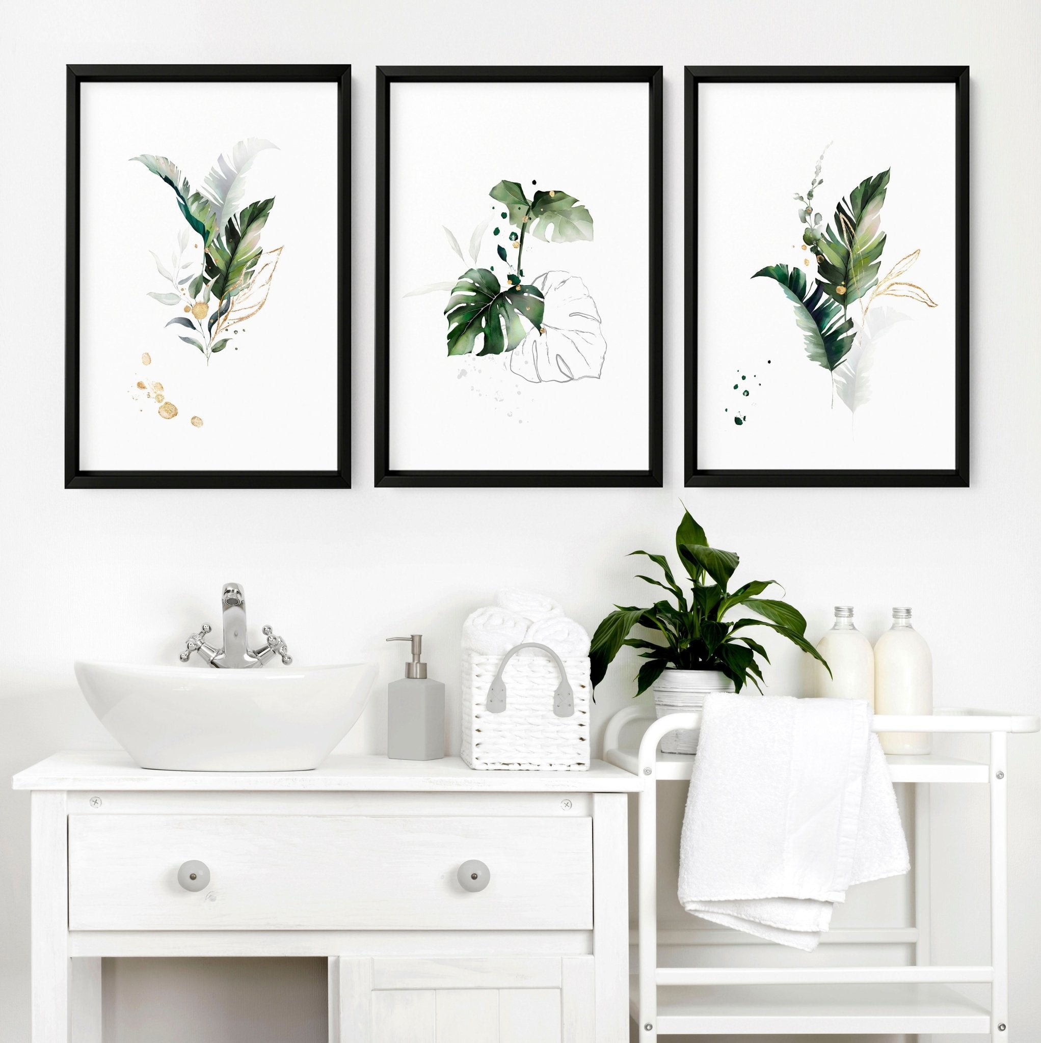 Set of 3 tropical wall art prints featuring lush greenery in greens and gold colors, perfect for bathroom decor.