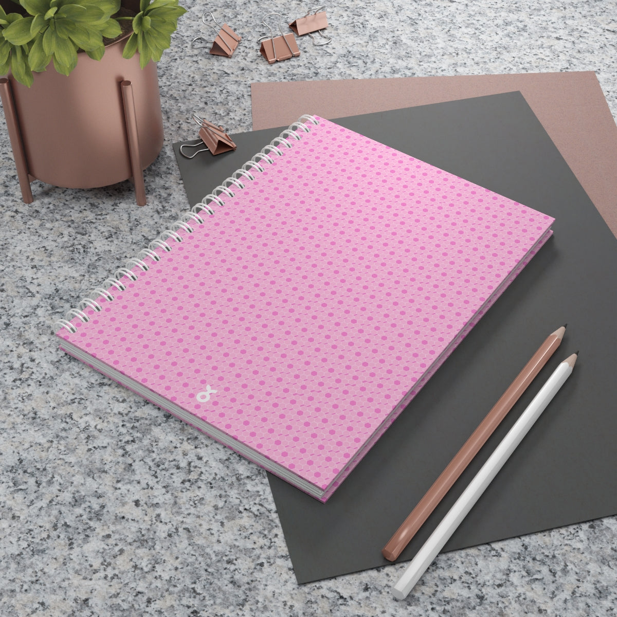 A stylish pink spiral notebook with customizable covers and wide-ruled pages, perfect for journaling and note-taking.