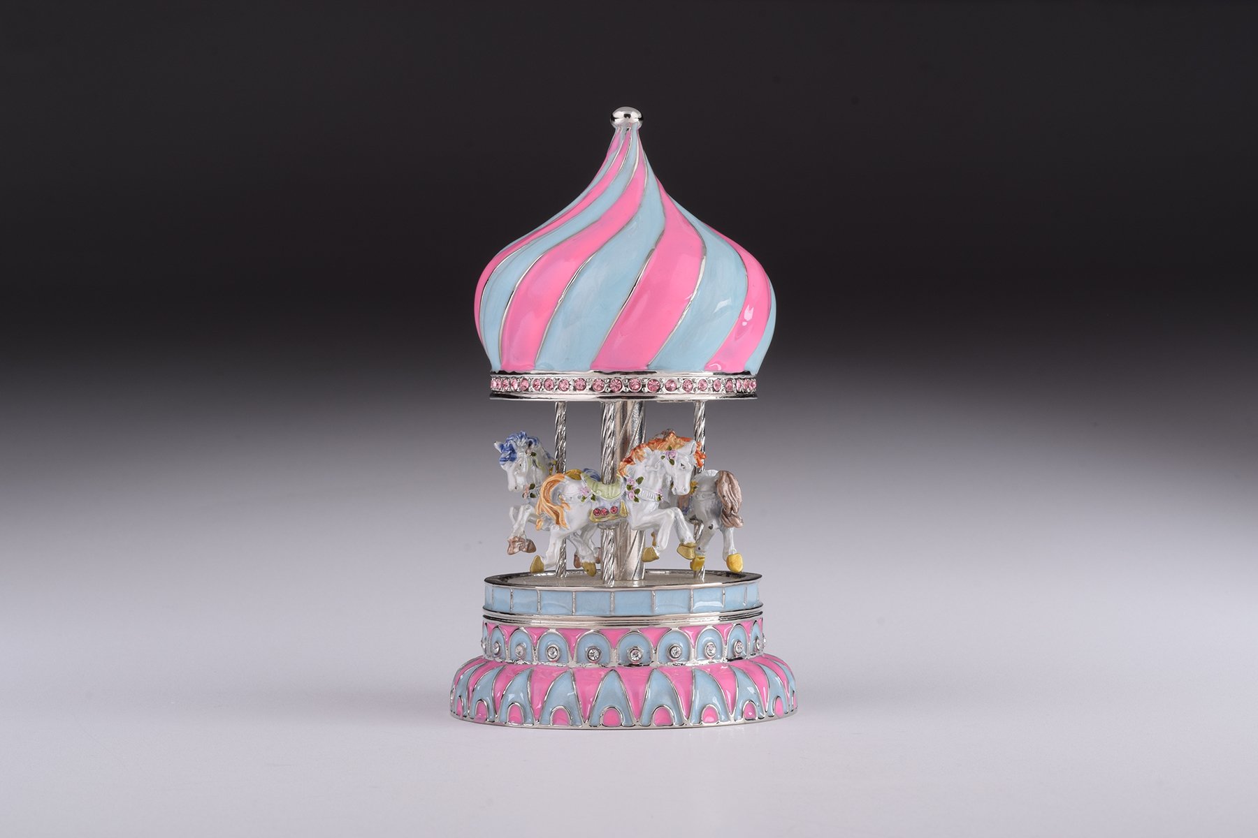 A beautifully crafted Pink Wind up Musical Carousel trinket box, adorned with Austrian crystals and plated with 24K Gold or 925 Silver.