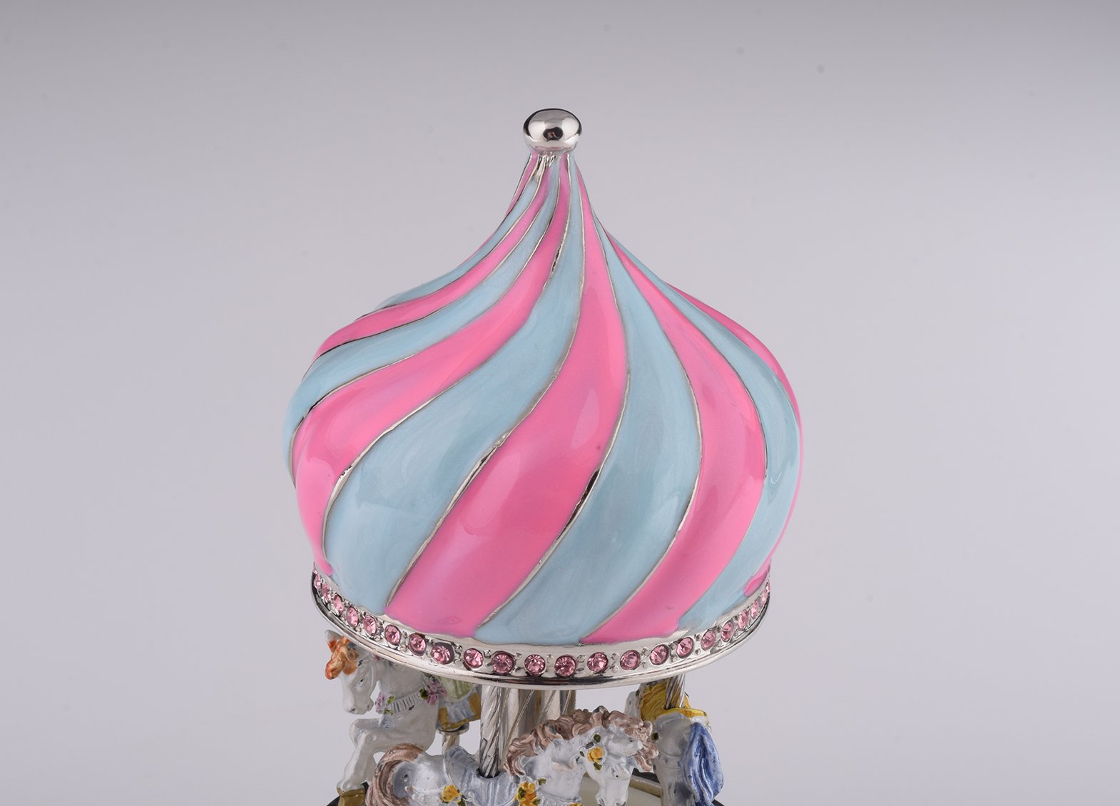 A beautifully crafted Pink Wind up Musical Carousel trinket box, adorned with Austrian crystals and plated with 24K Gold or 925 Silver.