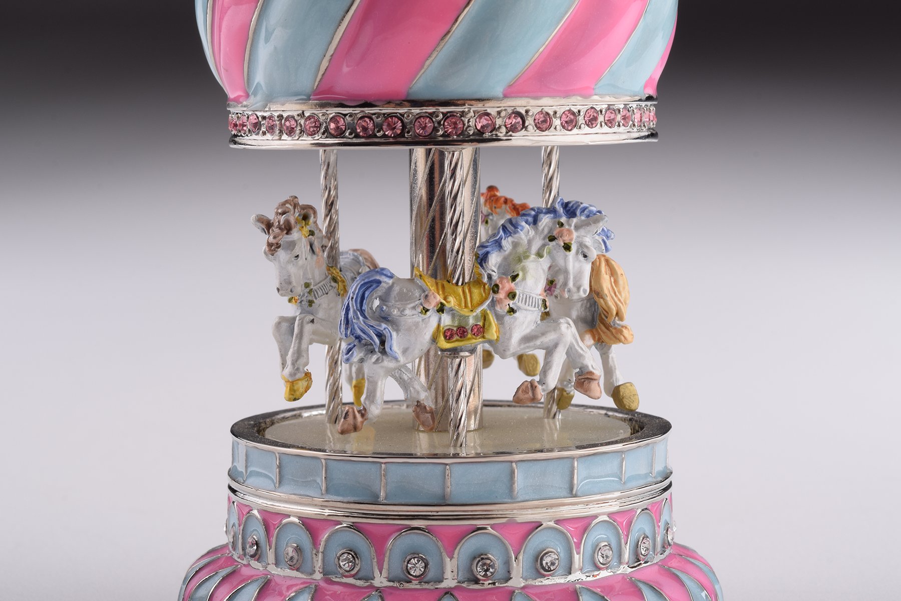 A beautifully crafted Pink Wind up Musical Carousel trinket box, adorned with Austrian crystals and plated with 24K Gold or 925 Silver.