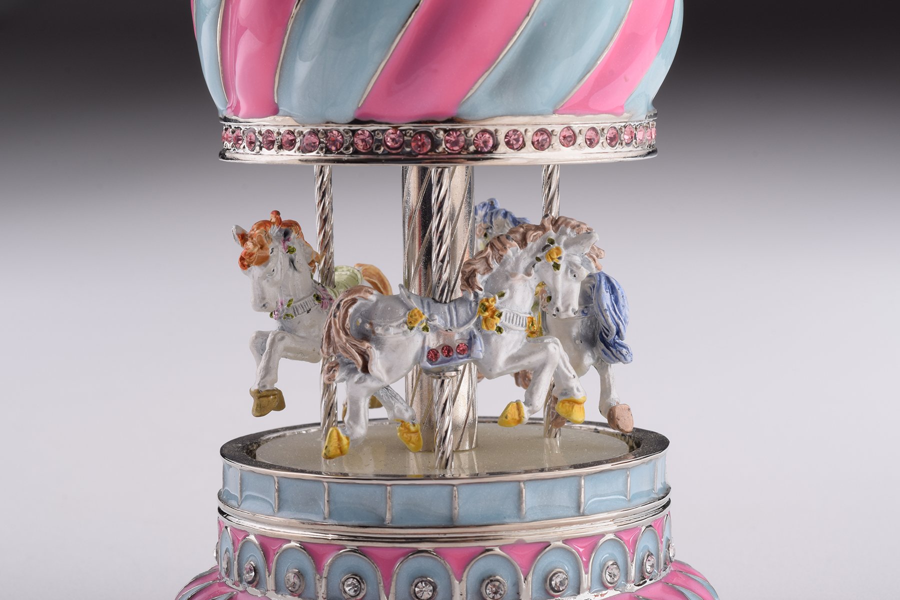 A beautifully crafted Pink Wind up Musical Carousel trinket box, adorned with Austrian crystals and plated with 24K Gold or 925 Silver.