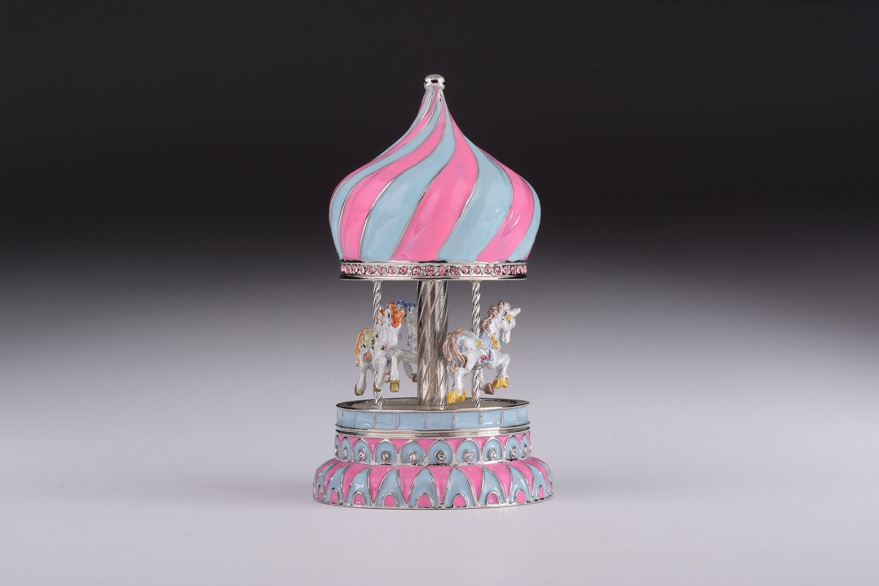 A beautifully crafted Pink Wind up Musical Carousel trinket box, adorned with Austrian crystals and plated with 24K Gold or 925 Silver.