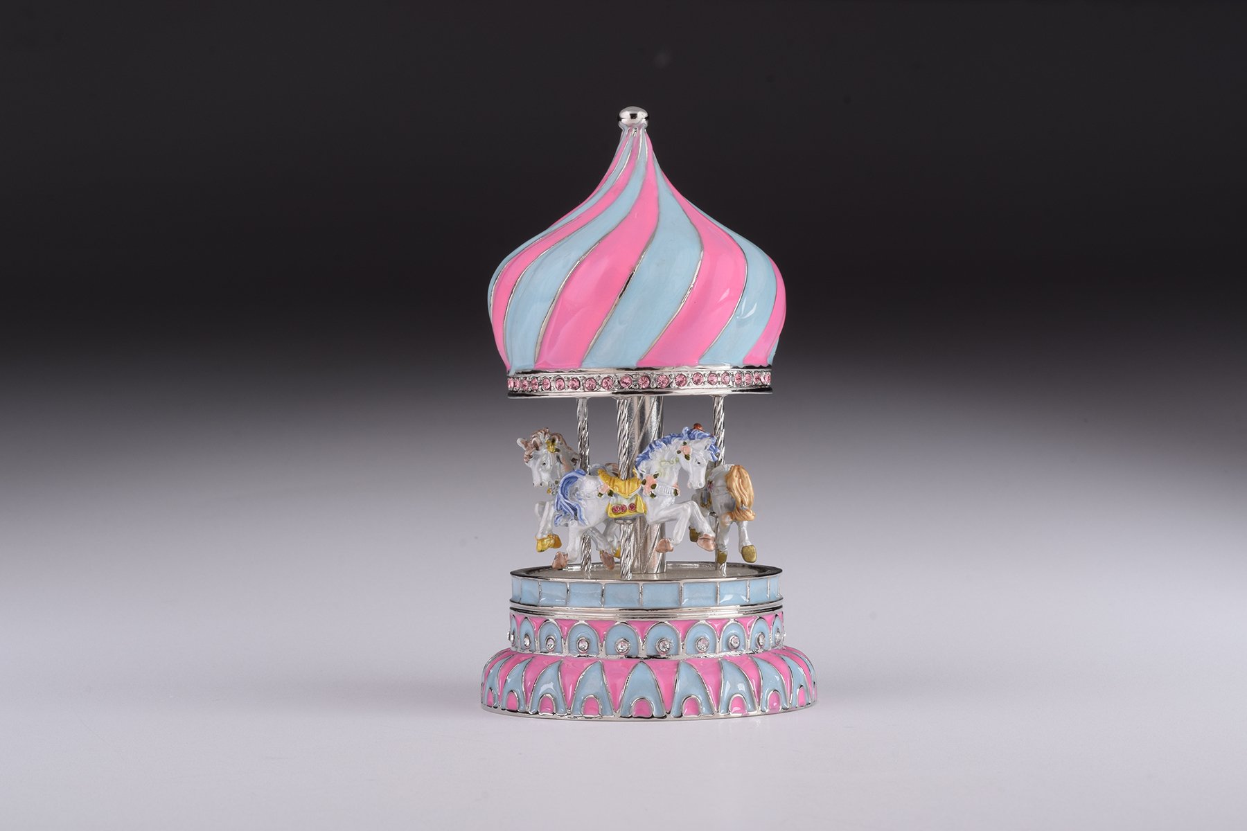 A beautifully crafted Pink Wind up Musical Carousel trinket box, adorned with Austrian crystals and plated with 24K Gold or 925 Silver.