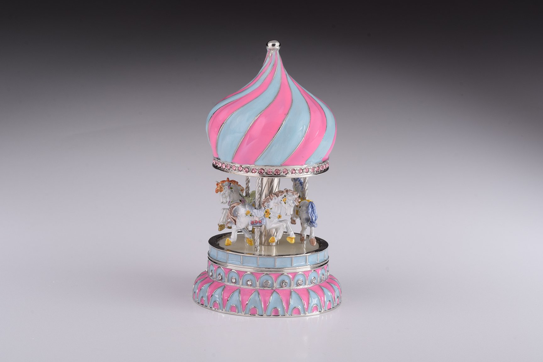A beautifully crafted Pink Wind up Musical Carousel trinket box, adorned with Austrian crystals and plated with 24K Gold or 925 Silver.