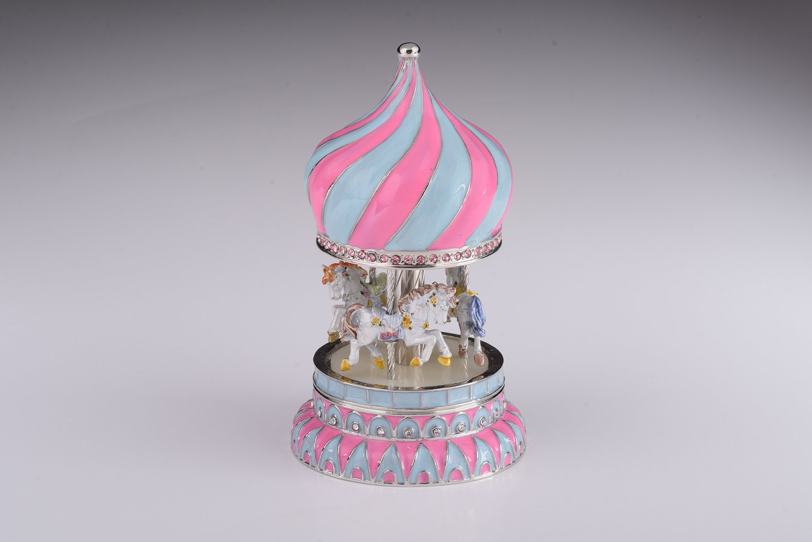 A beautifully crafted Pink Wind up Musical Carousel trinket box, adorned with Austrian crystals and plated with 24K Gold or 925 Silver.