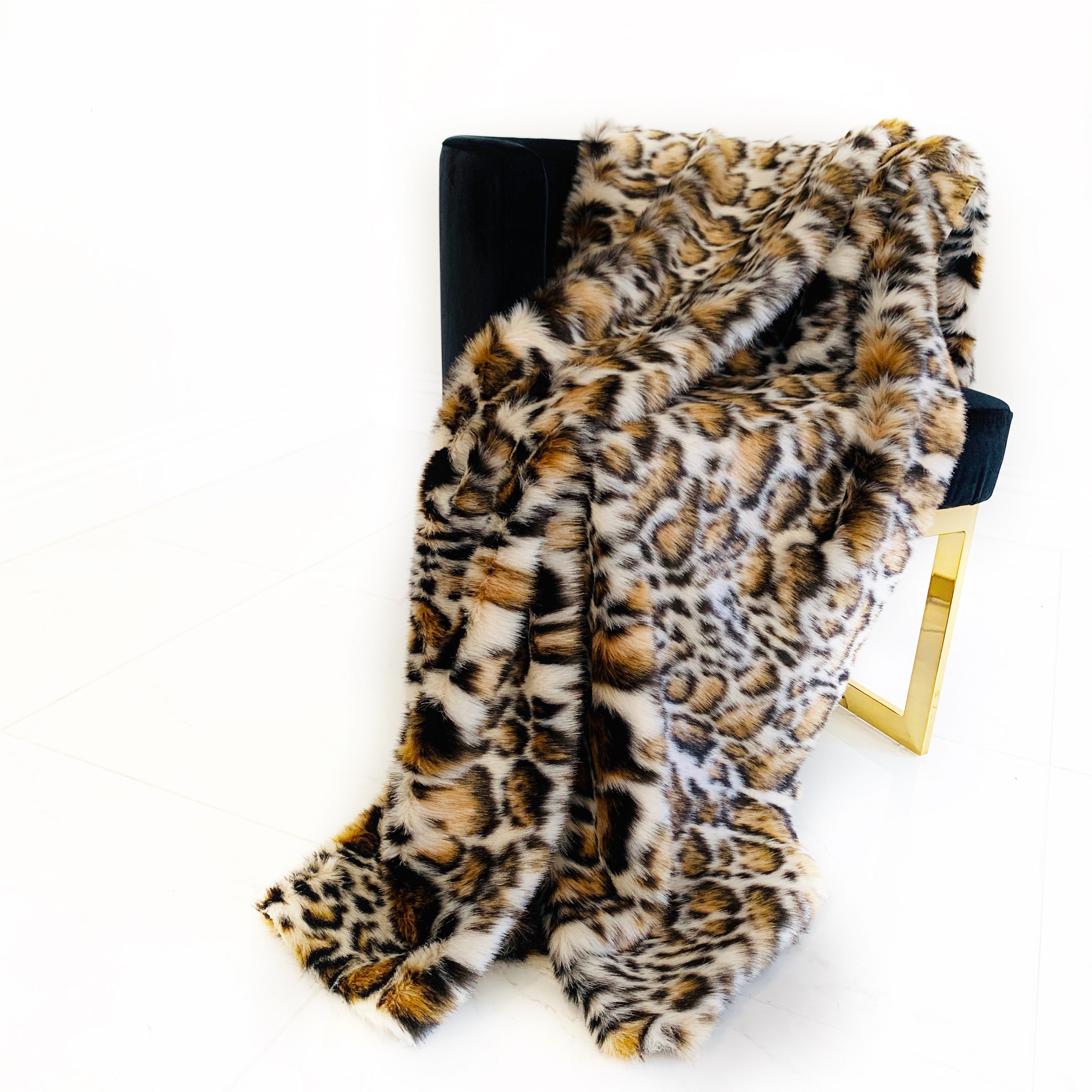Plutus Brown Tiger Faux Fur Luxury Throw Blanket featuring a taupe and black tiger print, showcasing its plush texture and reversible design.