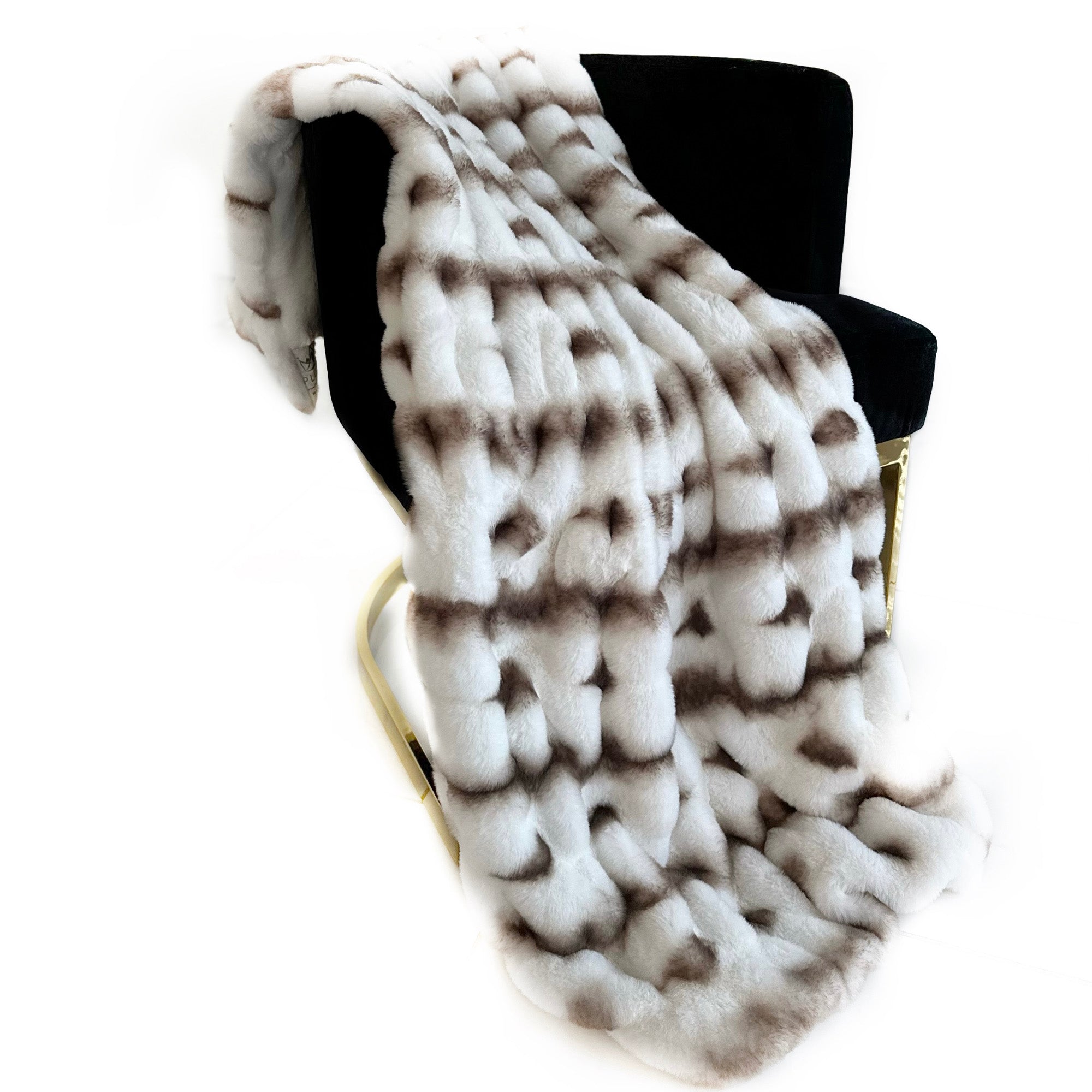 Plutus Creamy Fluffy Bunni Faux Fur Luxury Throw Blanket in a cozy setting, showcasing its soft texture and elegant creamy color.