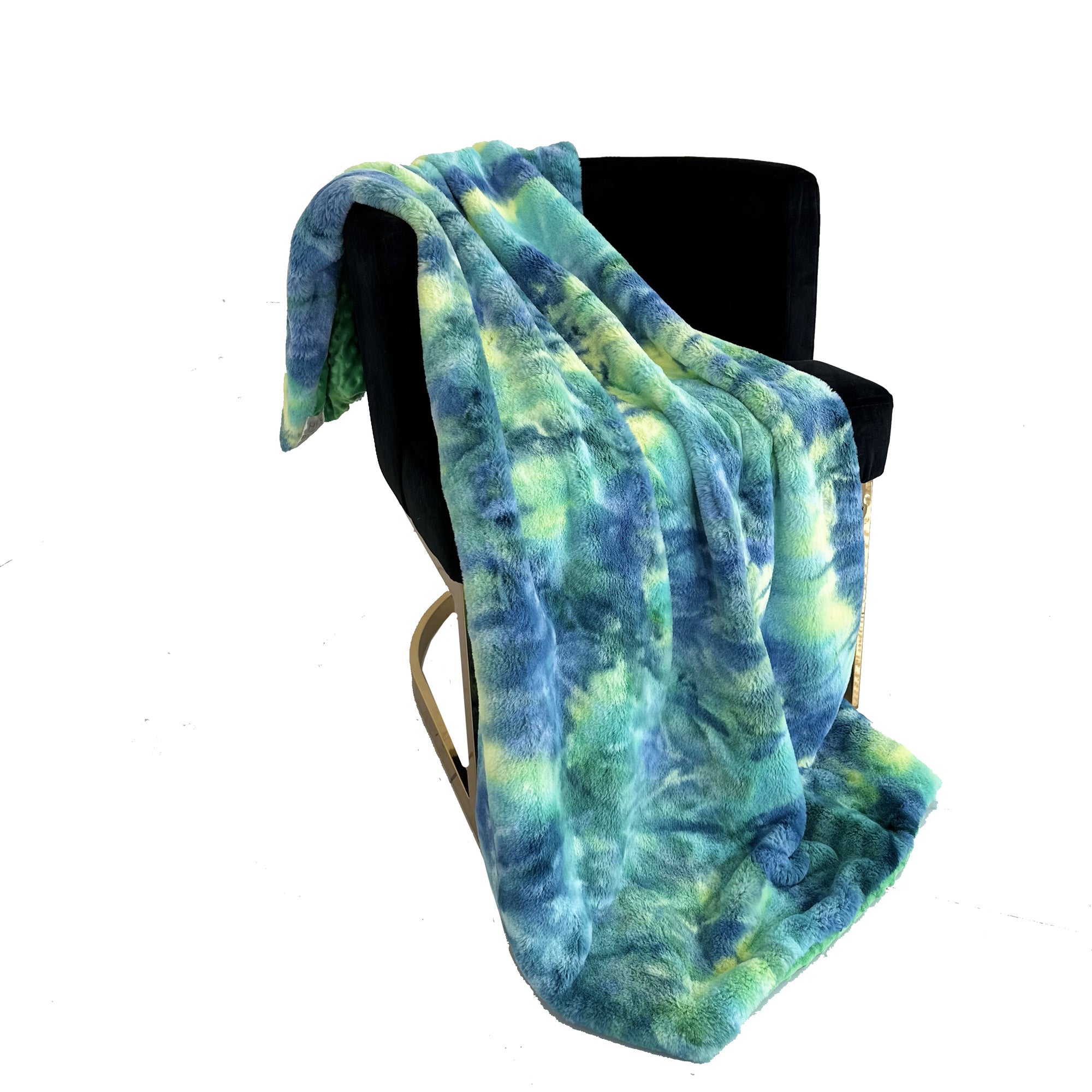 Plutus Green Yellow Blue Northern Lights Faux Fur Luxury Throw Blanket draped elegantly over a couch, showcasing its vibrant colors and plush texture.
