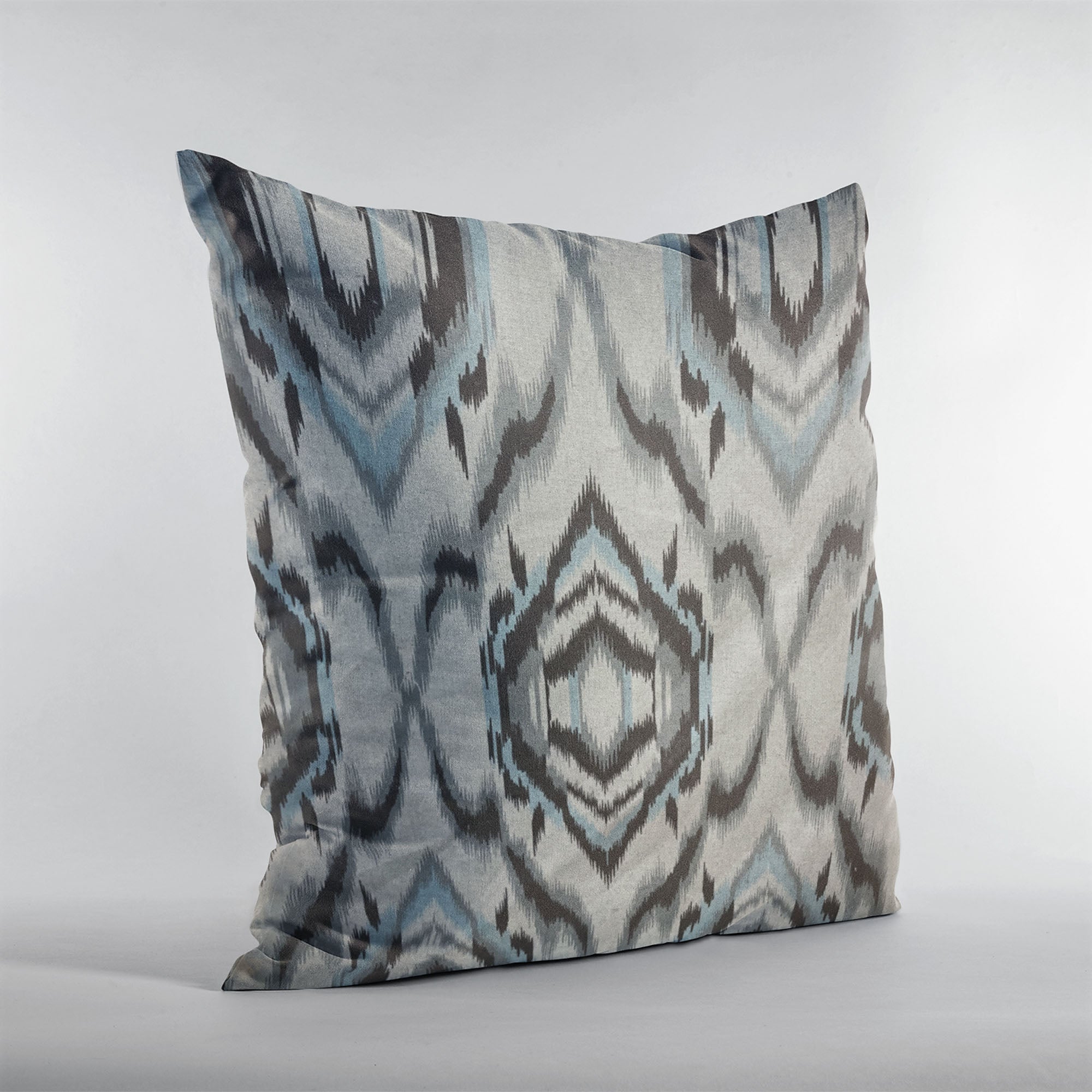 Plutus Ikat Dream Pillow in blue, black, and cream, showcasing a unique Ikat pattern with a luxurious handmade finish.