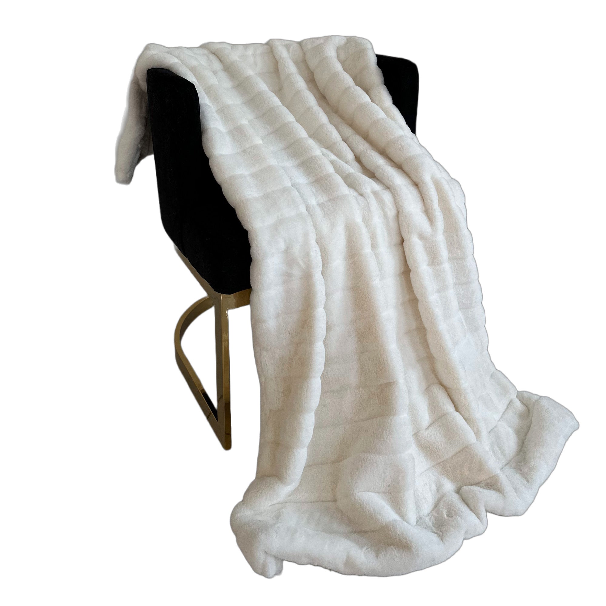 Plutus Off White Soft Snow Faux Fur Luxury Throw Blanket draped elegantly on a cozy couch, showcasing its plush texture and reversible design.