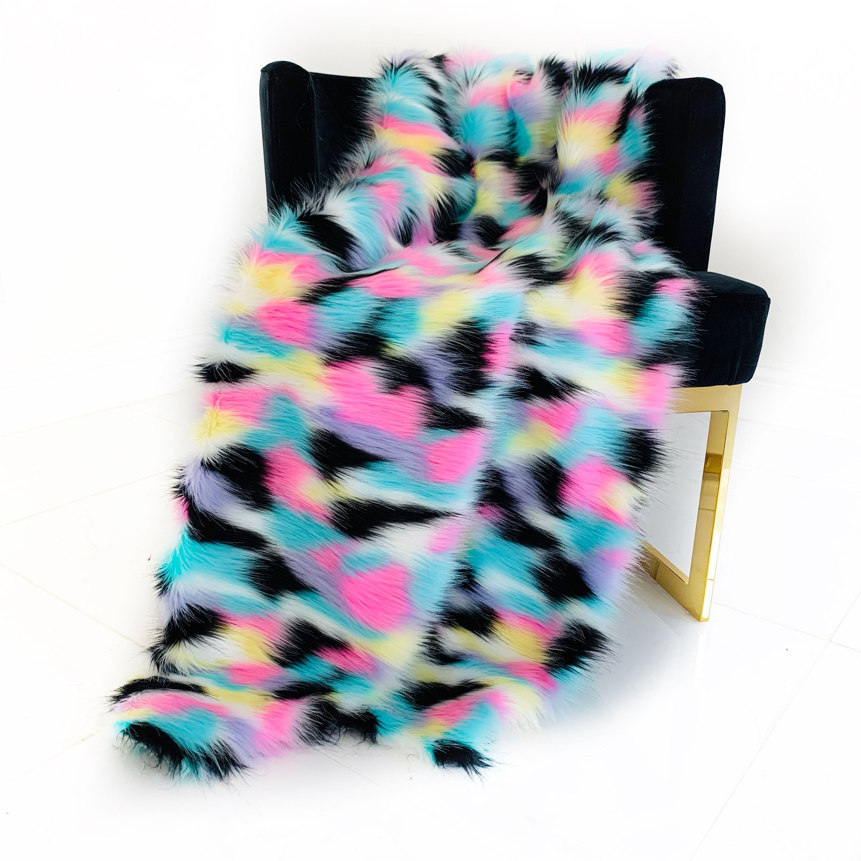 Plutus Exotic Faux Fur Luxury Throw Blanket in pink, blue, black, and yellow, showcasing its soft texture and vibrant colors.