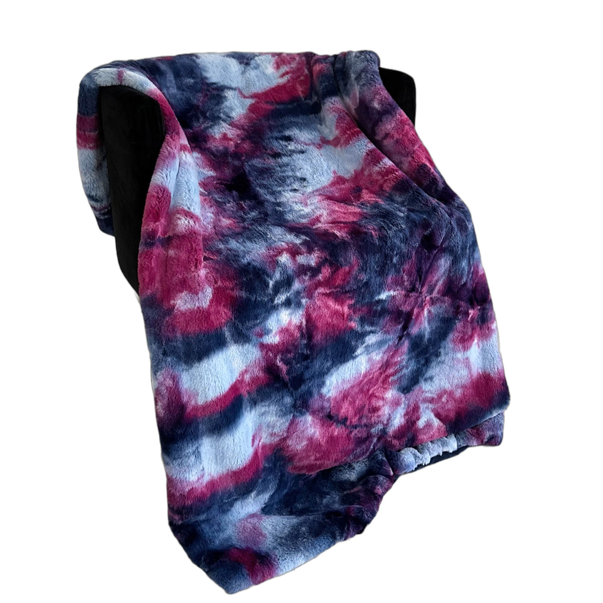 Plutus Purple Pink Faux Fur Luxury Throw Blanket draped elegantly over a chair, showcasing its plush texture and vibrant color.